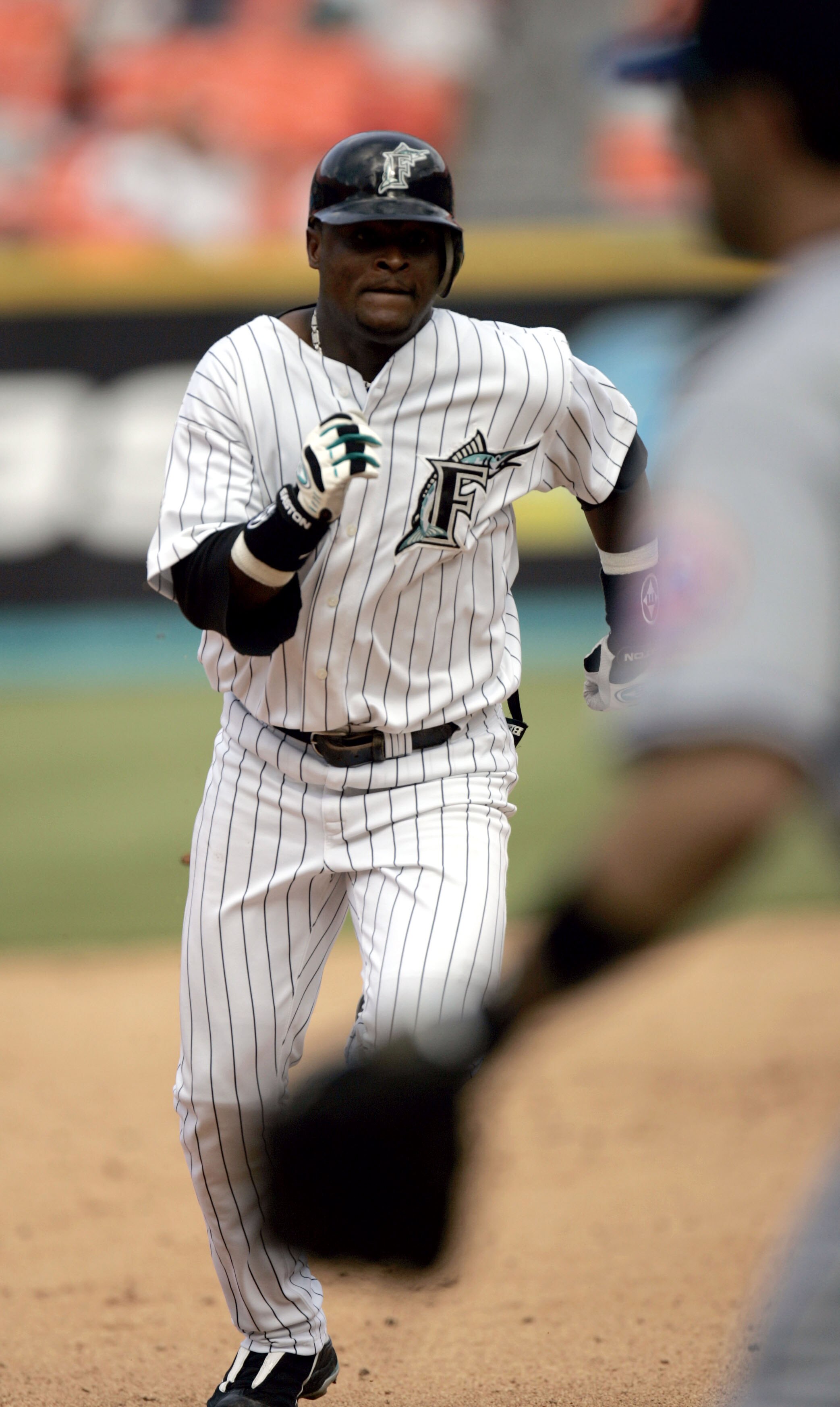 MIAMI - JULY 11: Second basemen Luis Castillo #1 of the Florida Marlins runs  into third base after hitting a triple in the seventh inning against the New York Mets on July 11, 2004 at Pro Player Stadium in Miami, Florida.  (Photo by Eliot J. Schechter/Ge