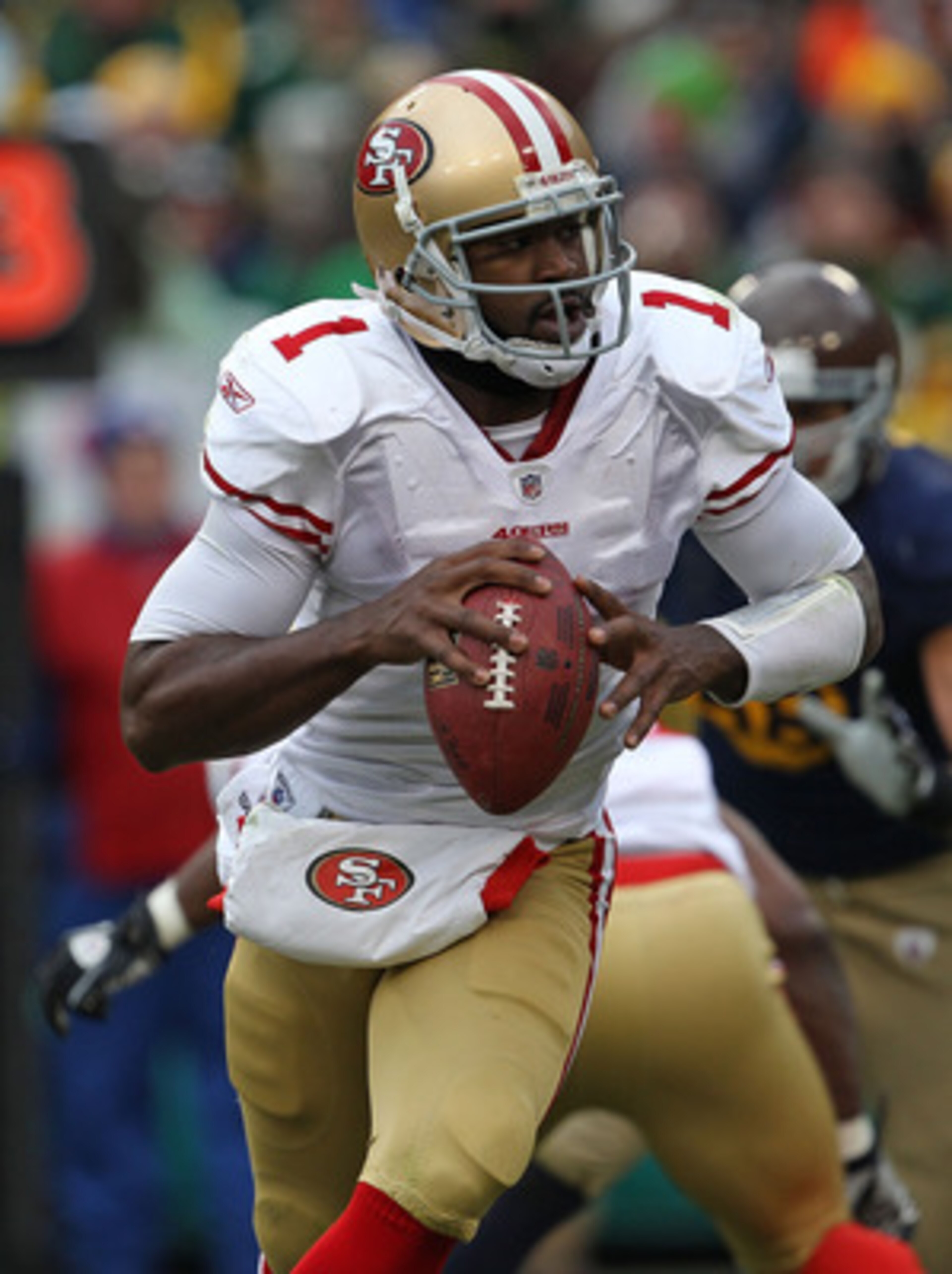 GREEN BAY, WI - DECEMBER 05: Troy Smith #1 of the San Francisco 49ers rolls out to look for a receiver against the Green Bay Packers at Lambeau Field on December 5, 2010 in Green Bay, Wisconsin. The Packers defeated the 49ers 34-16. (Photo by Jonathan Dan