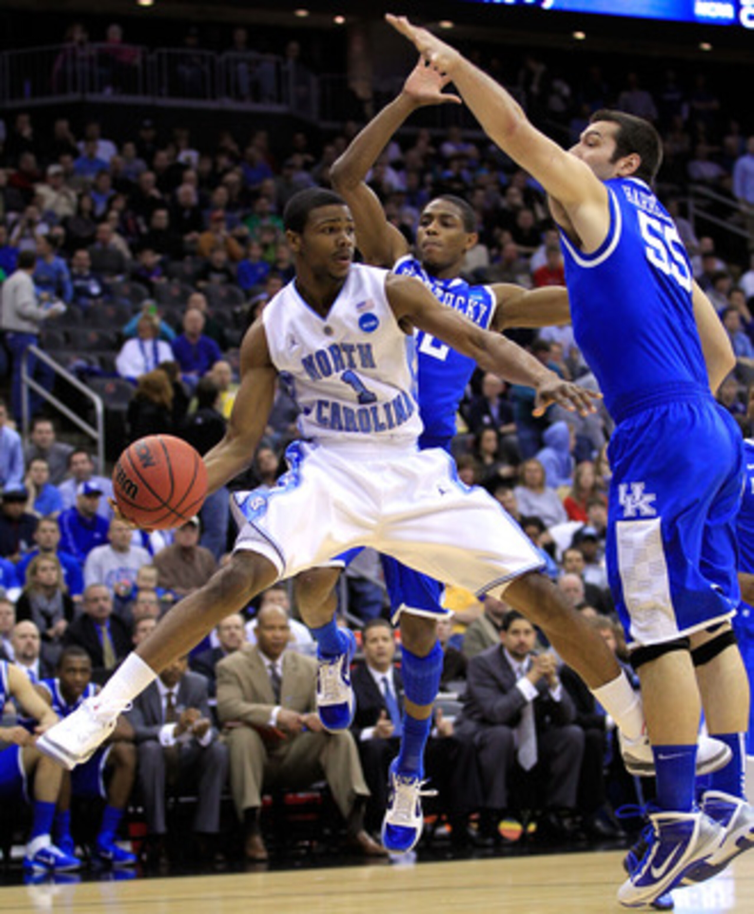 NEWARK, NJ - MARCH 27:  Dexter Strickland #1 of the North Carolina Tar Heels passes the ball against Josh Harrellson #55 and Brandon Knight #12 of the Kentucky Wildcats during the first half of the east regional final of the 2011 NCAA men's basketball tou