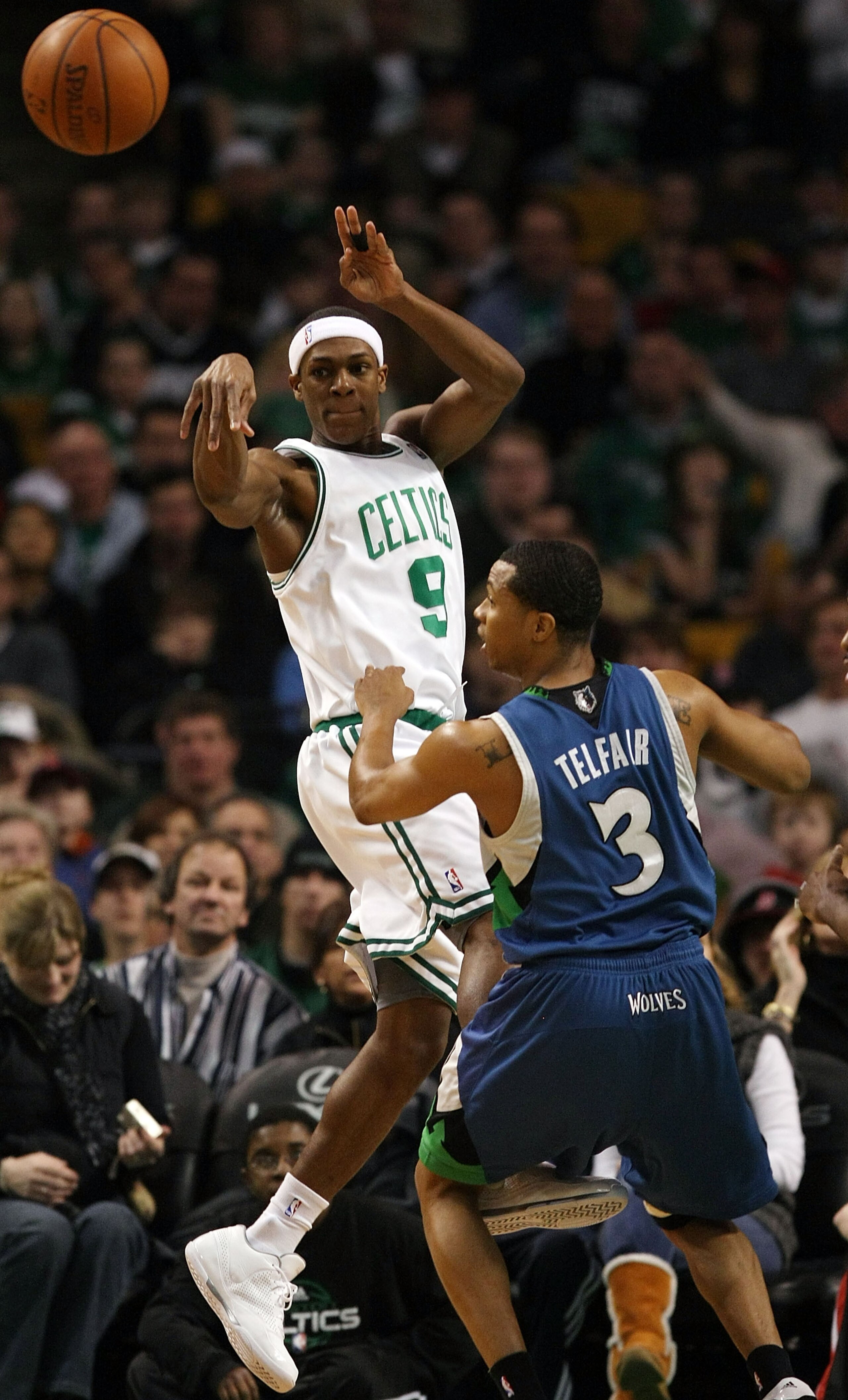 BOSTON - FEBRUARY 01:  Rajon Rondo #9 of the Boston Celtics passes the ball as Sebastian Telfair #3 of Minnesota Timberwolves defends on February 1, 2009 at TD Banknorth Garden in Boston, Massachusetts. The Celtics defeated the Timberwolves 109-101. NOTE
