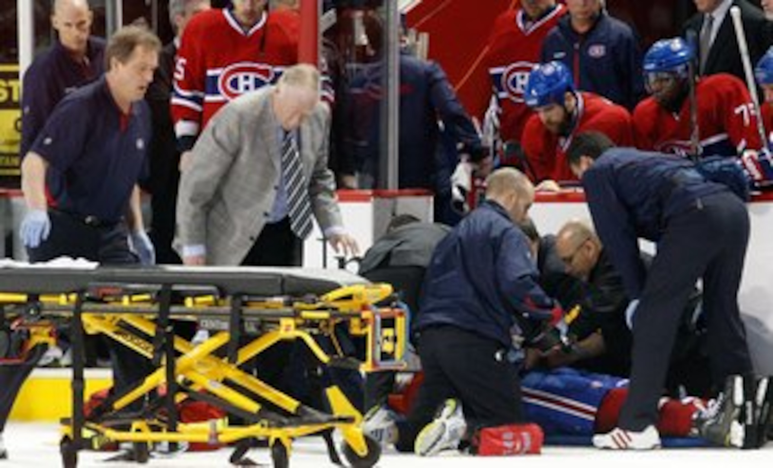 MONTREAL, CANADA - MARCH 8:  Members of the Montreal Canadiens medical staff tend to Max Pacioretty #67 of the Montreal Canadiens after being hit by Zdeno Chara #33 of the Boston Bruins (not pictured) during the NHL game at the Bell Centre on March 8, 201
