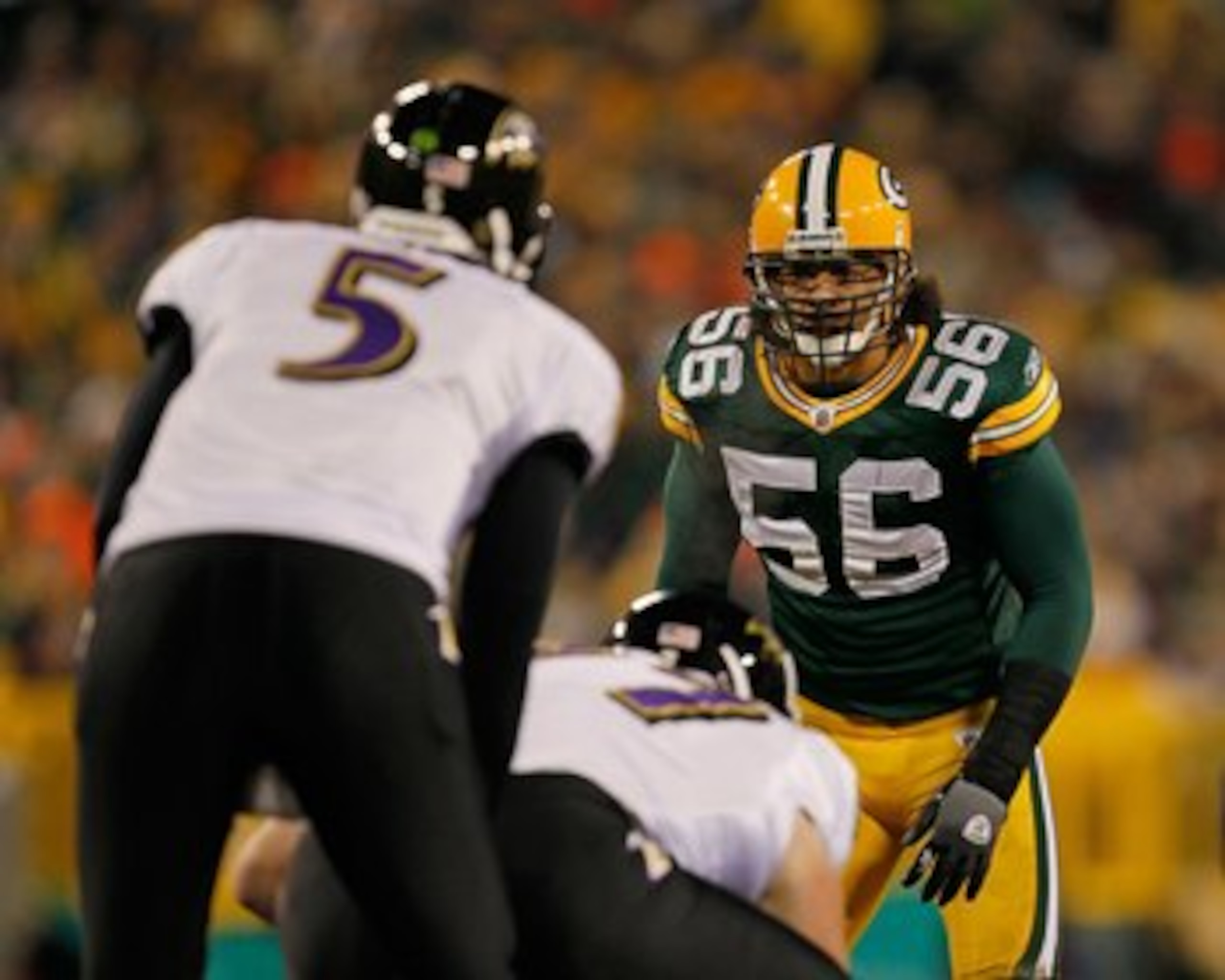 GREEN BAY, WI - DECEMBER 07: Nick Barnett #56 of the Green Bay Packers stares at Joe Flacco #5 of the Baltimore Ravens before the snap at Lambeau Field on December 7, 2009 in Green Bay, Wisconsin. The Packers defeated the Ravens 27-17. (Photo by Jonathan