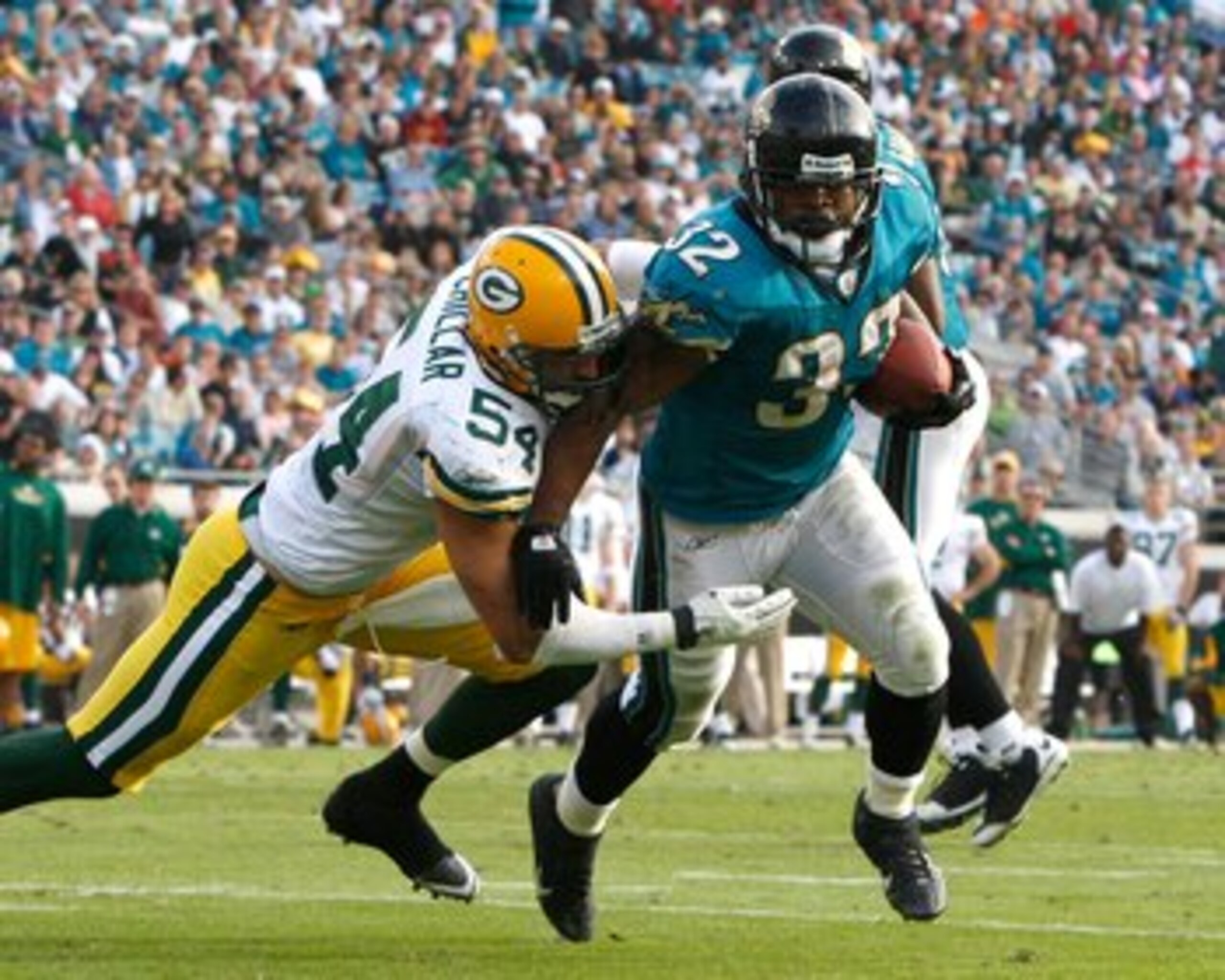 JACKSONVILLE, FL - DECEMBER 14:  Maurice Jones-Drew #32 of the Jacksonville Jaguars breaks the tackle of Brandon Chillar #54 of the Green Bay Packers during the game at Jacksonville Municipal stadium on December 14, 2008 in Jacksonville, Florida.  (Photo