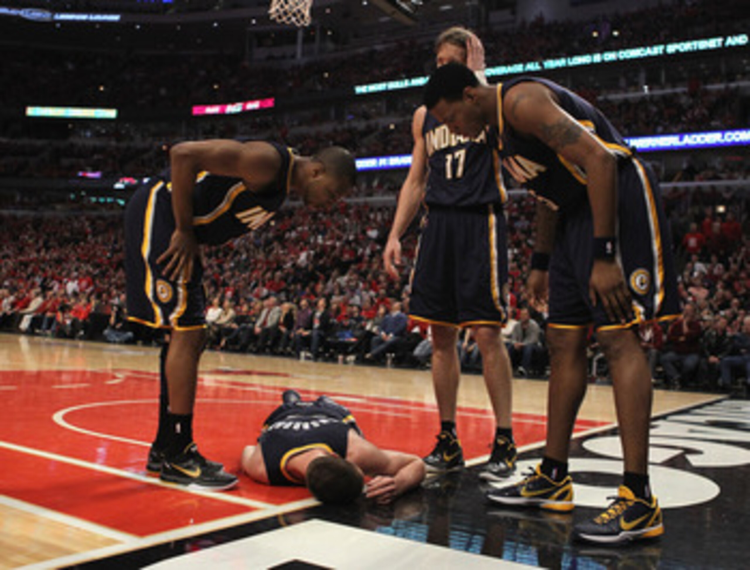 CHICAGO, IL - APRIL 16: (L-R) A.J. Price #12, Mike Dunleavy #17 and Brandon Rush #25 of the Indiana Pacers look down at fallen teammate Tyler Hansbrough #50 after Hansbrough hit the floor on a play against the Chicago Bulls in Game One of the Eastern Conf