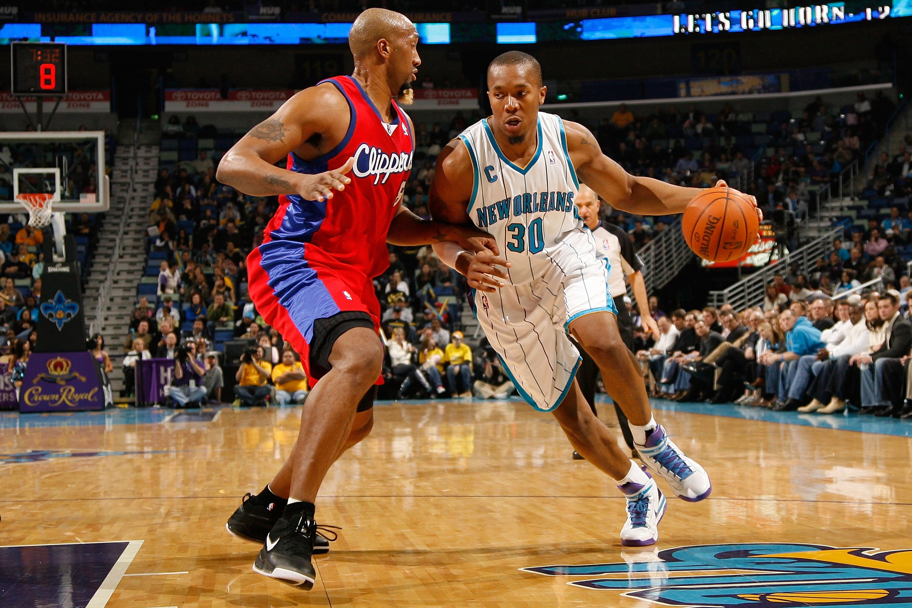 NEW ORLEANS - JANUARY 13:  David West #30  of the New Orleans Hornets drives the ball around Brian Skinner #8 of the Los Angeles Clippers at the New Orleans Arena on January 13, 2010 in New Orleans, Louisiana.  The Hornets defeated the Clippers 108-94.  N