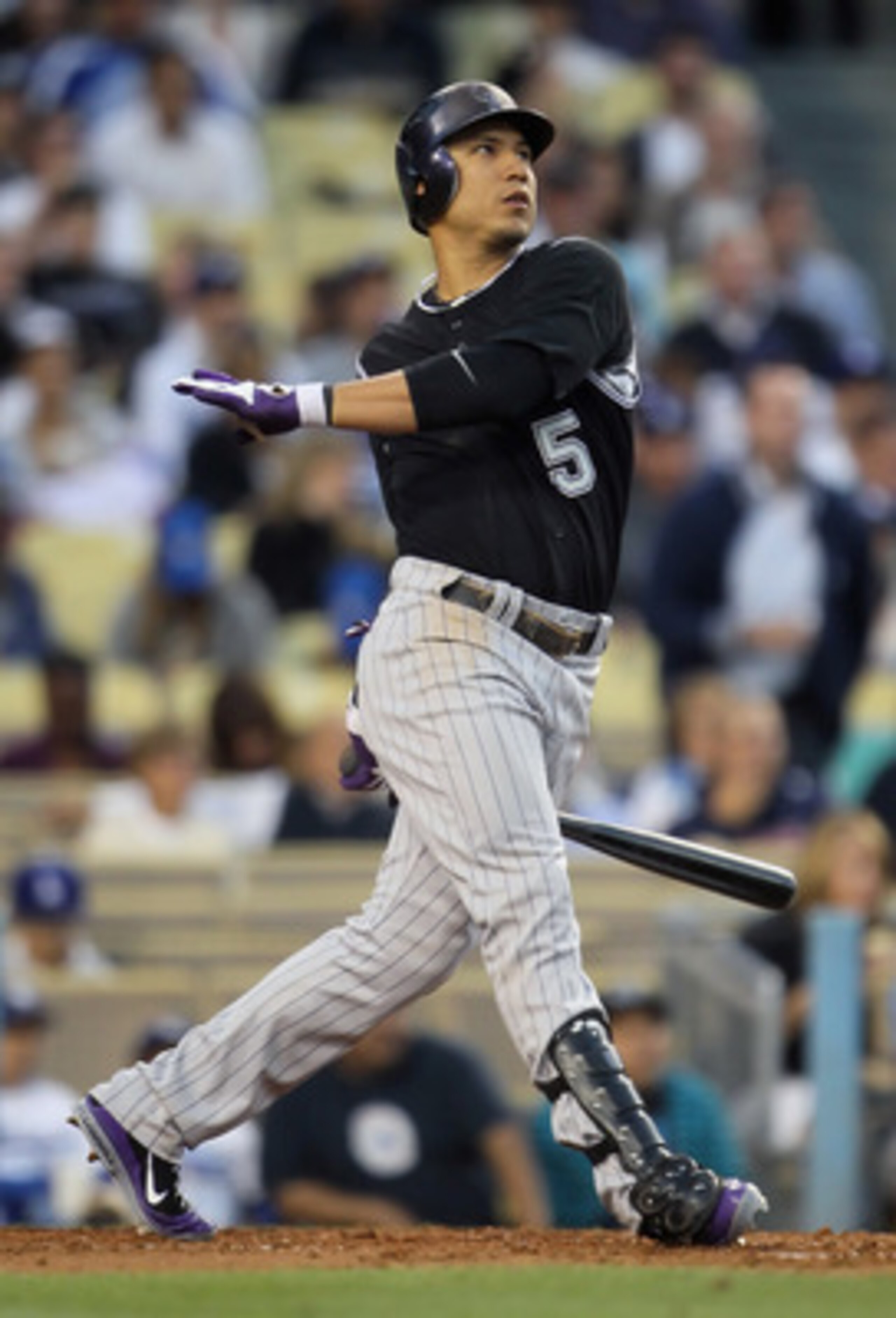 LOS ANGELES, CA - JUNE 01:  Carlos Gonzalez #5 of the Colorado Rockies hits a sacrifice fly in the third inning against the Los Angeles Dodgers at Dodger Stadium on June 1, 2011 in Los Angeles, California. The Rockies defeated the Dodgers 3-0.  (Photo by 