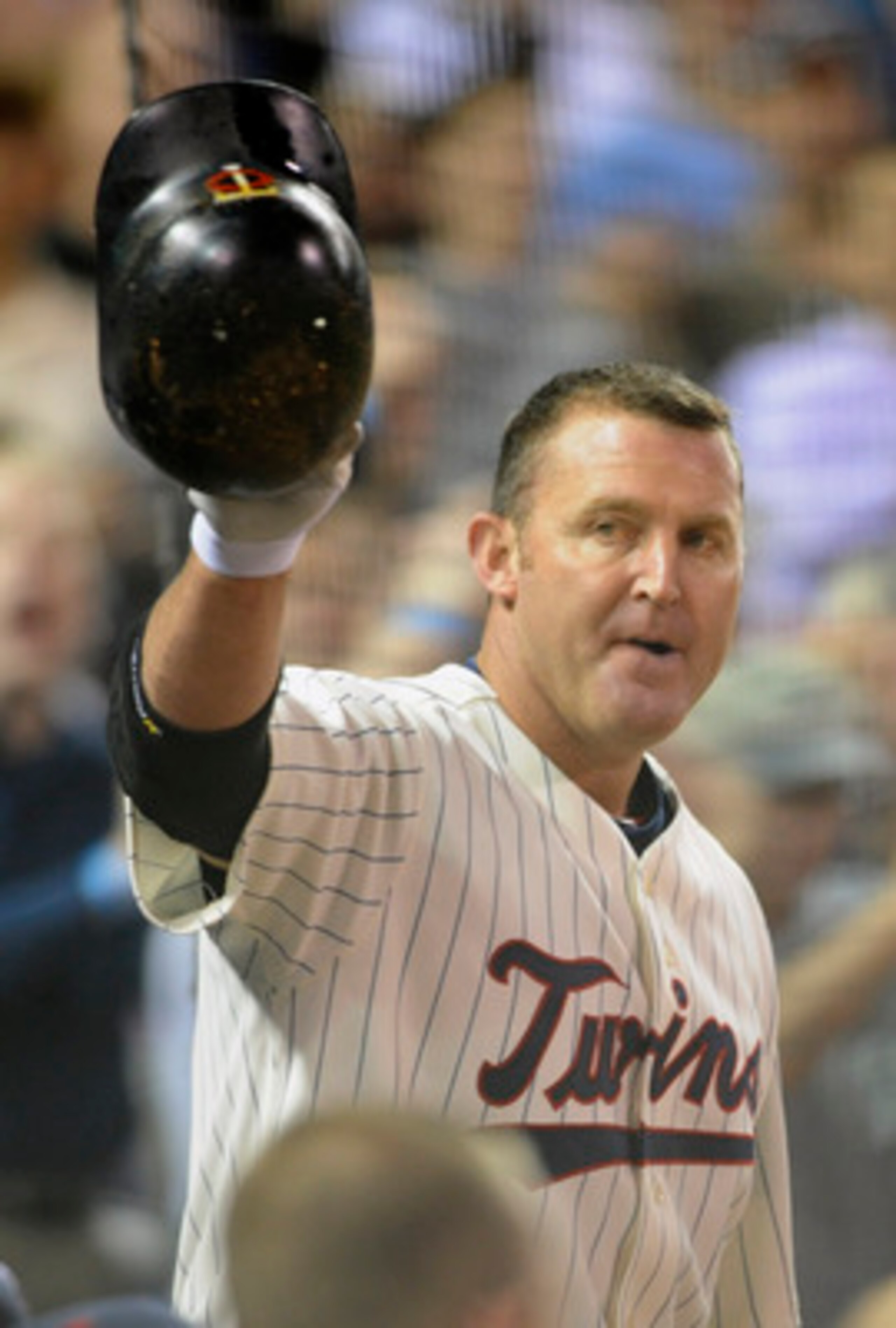 MINNEAPOLIS, MN - MAY 23:  Jim Thome #25 of the Minnesota Twins steps out of the dugout for a curtain call following his second home run against the Seattle Mariners in the seventh inning of their game on May 16, 2011 at Target Field in Minneapolis, Minne
