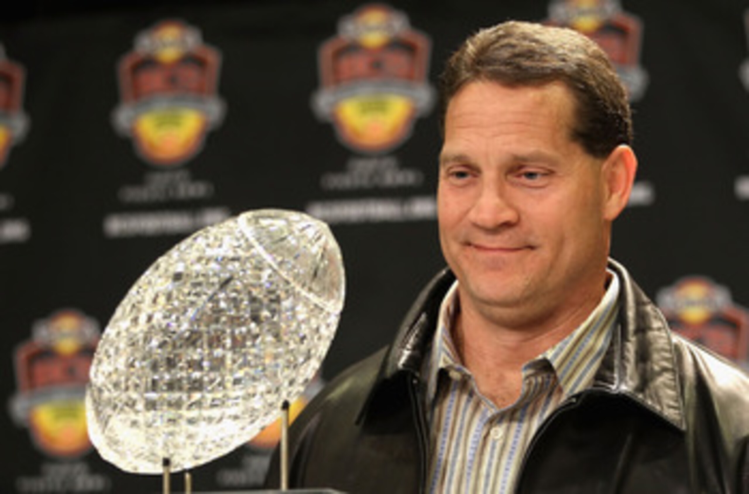 SCOTTSDALE, AZ - JANUARY 11:  Head coach Gene Chizik of the Auburn Tigers poses with the Coaches trophys during a press conference for the Tostitos BCS National Championship Game at the JW Marriott Camelback Inn on January 11, 2011 in Scottsdale, Arizona.
