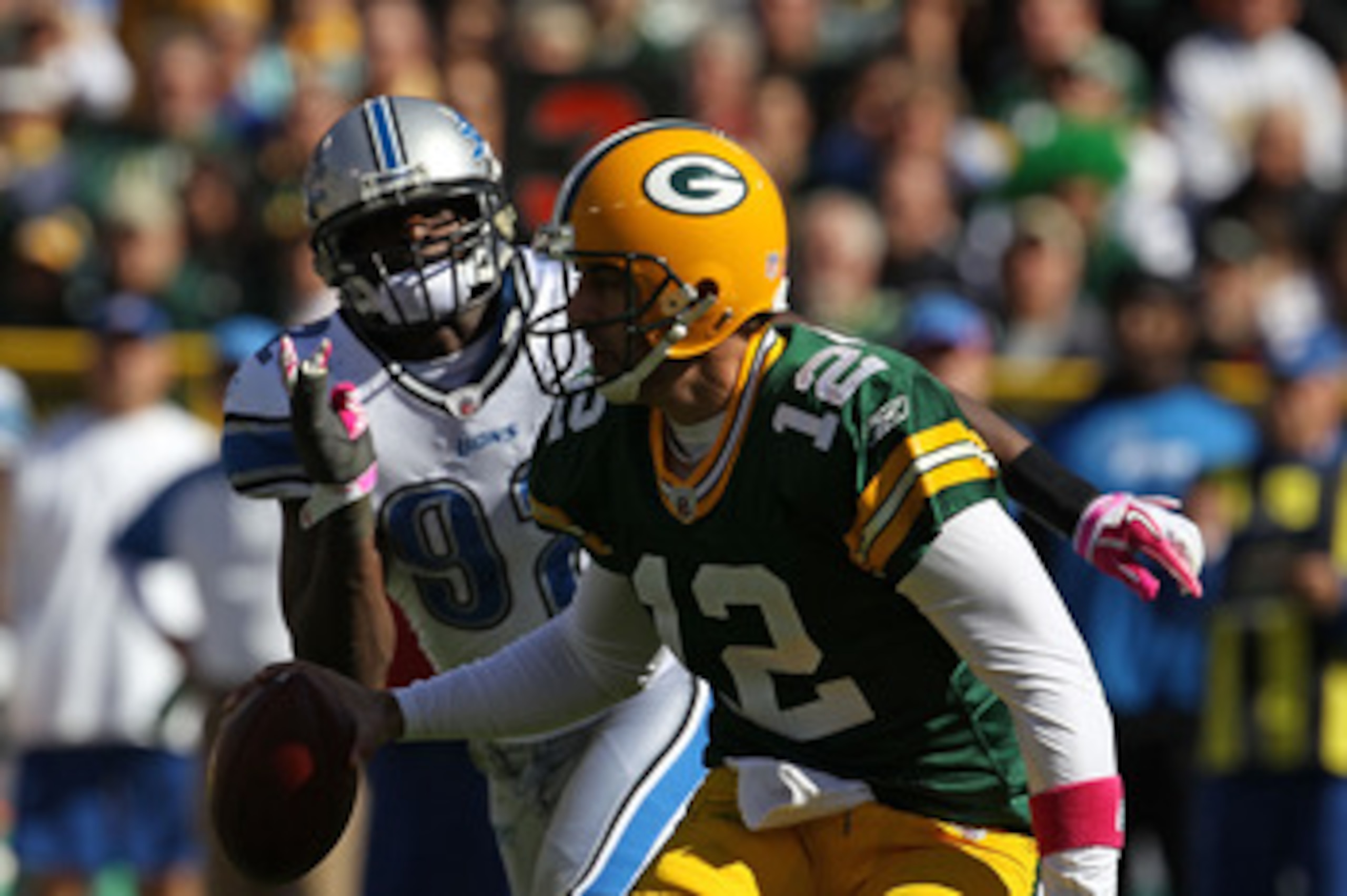 GREEN BAY, WI - OCTOBER 03: Aaron Rodgers #12 of the Green Bay Packers moves to avoid Cliff Avril #92 of the Detroit Lions at Lambeau Field on October 3, 2010 in Green Bay, Wisconsin. (Photo by Jonathan Daniel/Getty Images) GREEN BAY, WI - OCTOBER 03: Aaron Rodgers #12 of the Green Bay Packers moves to avoid Cliff Avril #92 of the Detroit Lions at Lambeau Field on October 3, 2010 in Green Bay, Wisconsin. (Photo by Jonathan Daniel/Getty Images)