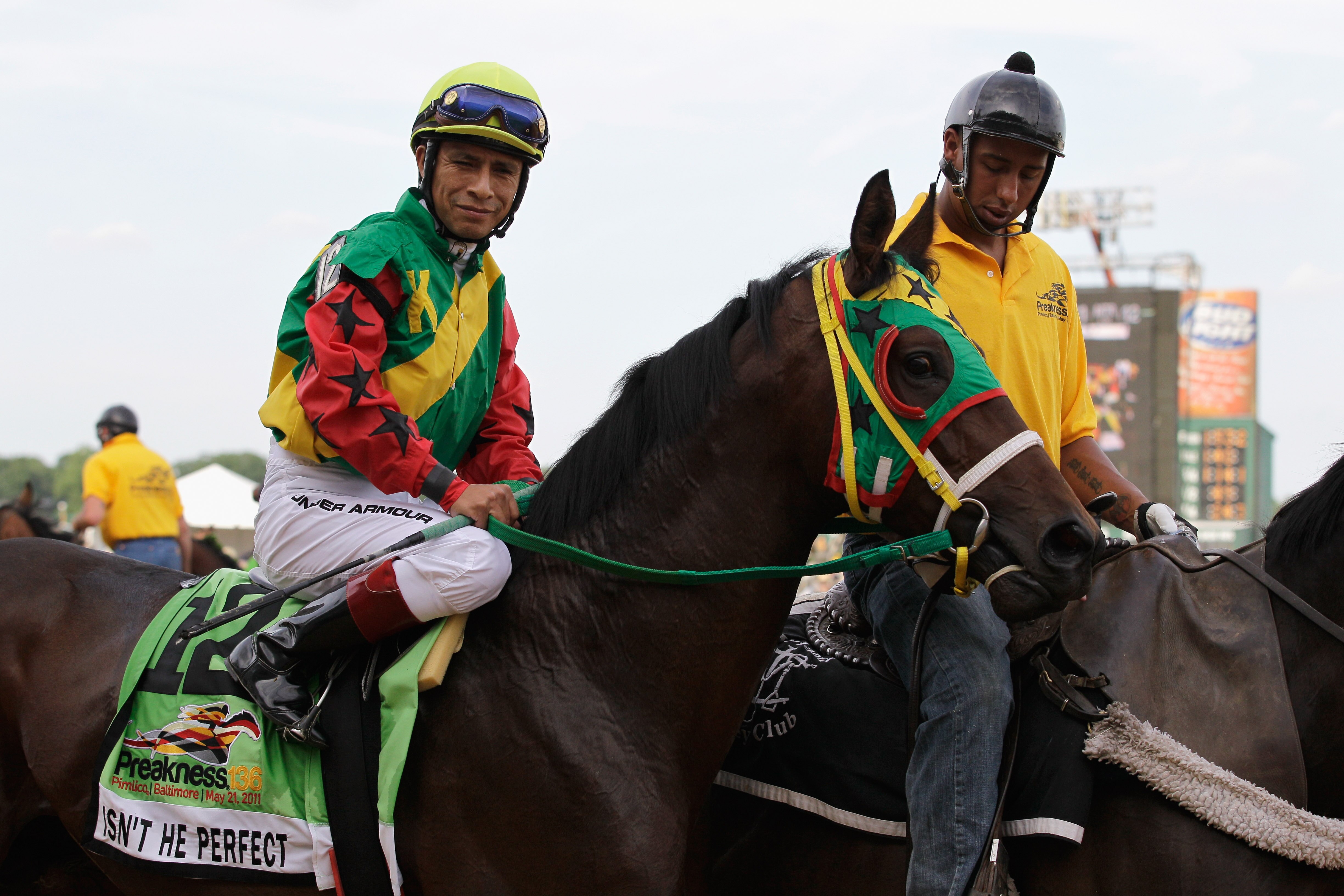 BALTIMORE, MD - MAY 21: Isn't He Perfect with jockey Ramon Dominguez #12 during the post parade for the 136th running of the Preakness Stakes at Pimlico Race Course on May 21, 2011 in Baltimore, Maryland.  (Photo by Rob Carr/Getty Images)