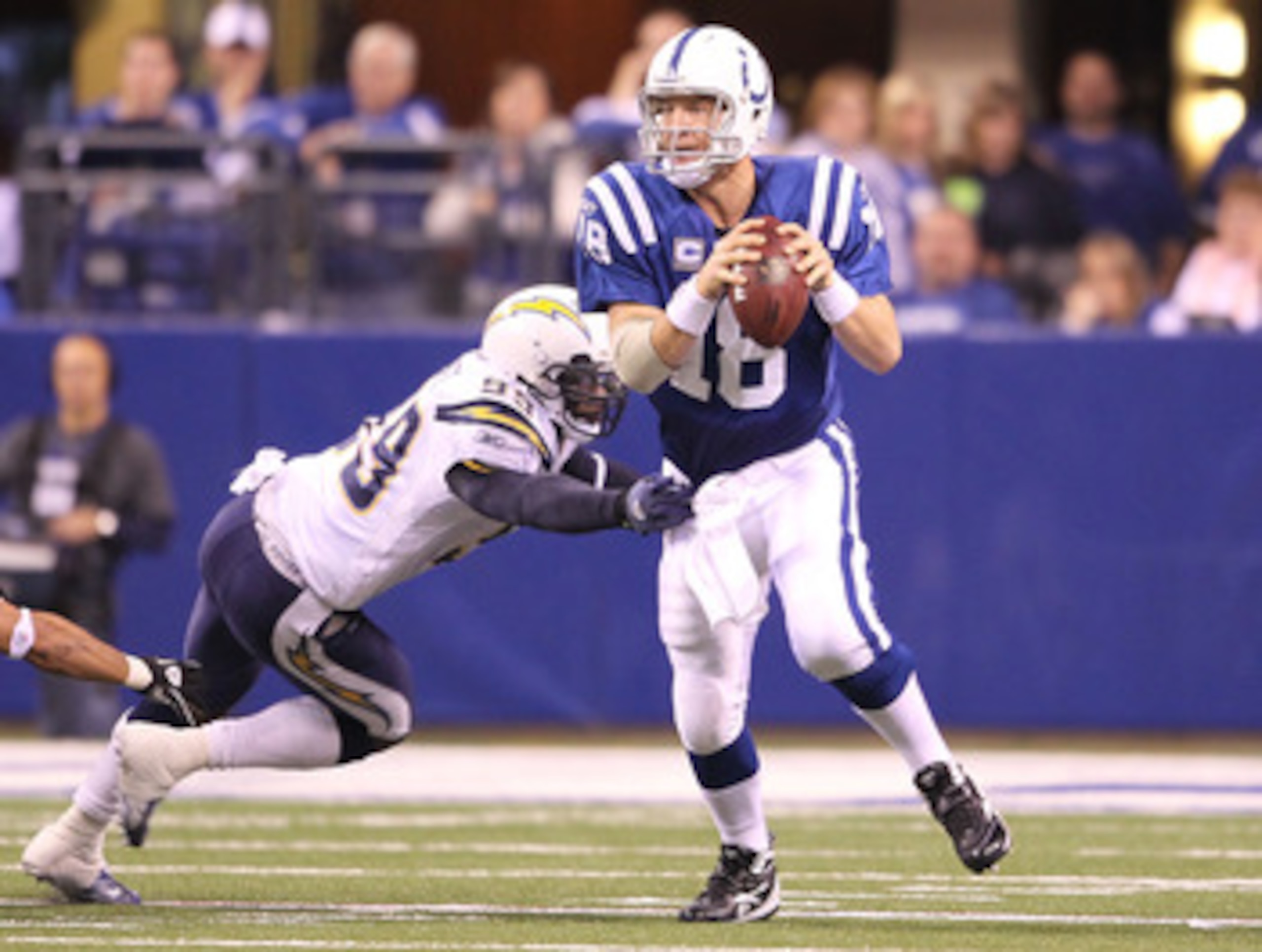 INDIANAPOLIS - NOVEMBER 28: Peyton Manning #18 of the Indianapolis Colts looks to throw a pass while pursued by Kevin Burnett #99 of the San Diego Chargers during the NFL game at Lucas Oil Stadium on November 28, 2010 in Indianapolis, Indiana. The Charg INDIANAPOLIS - NOVEMBER 28: Peyton Manning #18 of the Indianapolis Colts looks to throw a pass while pursued by Kevin Burnett #99 of the San Diego Chargers during the NFL game at Lucas Oil Stadium on November 28, 2010 in Indianapolis, Indiana. The Charg