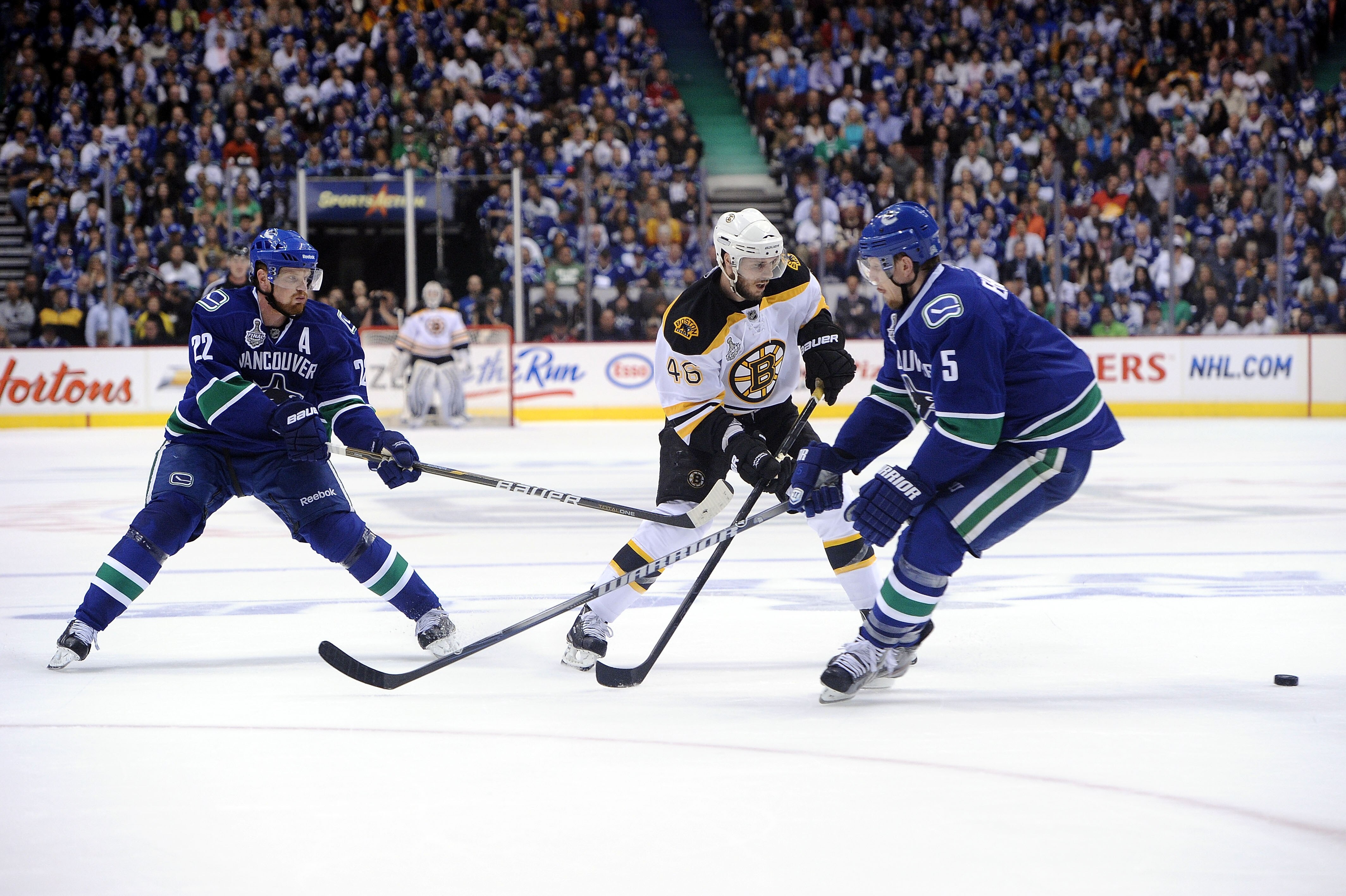 VANCOUVER, BC - JUNE 01: Daniel Sedin #22 and Christian Ehrhoff #5 of the Vancouver Canucks skates against the Boston Bruins during game one of the 2011 NHL Stanley Cup Finals at Rogers Arena on June 1, 2011 in Vancouver, Canada.  (Photo by Harry How/Gett
