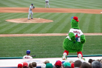 PHILADELPHIA, PA - MAY 22: Philadelphia Phillies mascot Phillie Phanatic tries to distract pitcher Matt Harrison #54 of the Texas Rangers at Citizens Bank Park on May 22, 2011 in Philadelphia, Pennsylvania. The Rangers won 2-0. (Photo by Joe Robbins/Getty