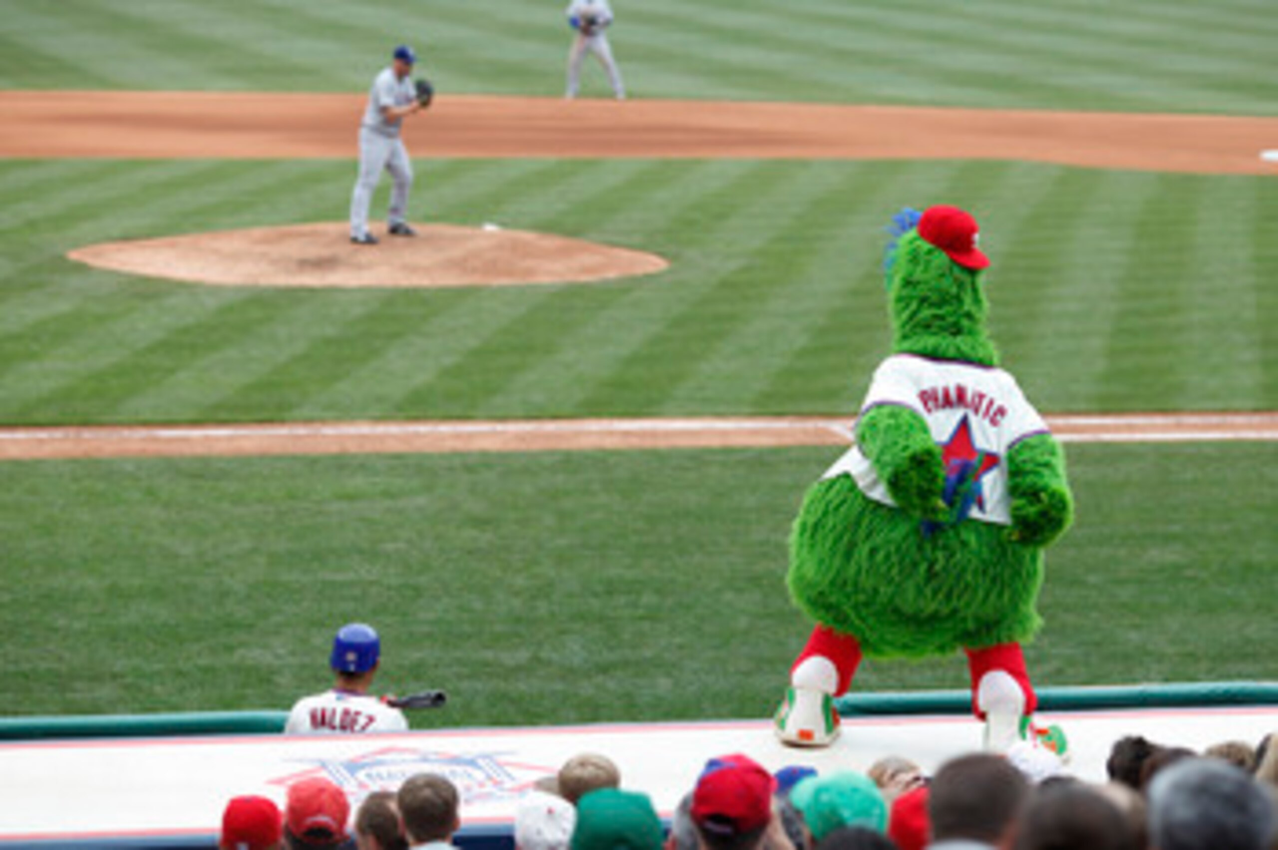 PHILADELPHIA, PA - MAY 22: Philadelphia Phillies mascot Phillie Phanatic tries to distract pitcher Matt Harrison #54 of the Texas Rangers at Citizens Bank Park on May 22, 2011 in Philadelphia, Pennsylvania. The Rangers won 2-0. (Photo by Joe Robbins/Getty