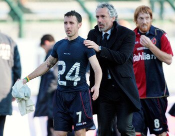 CAGLIARI, ITALY - FEBRUARY 13:  Roberto Donadoni (R) coach of Cagliari and Andrea Cossu look on during the Serie A match between Cagliari Calcio and AC Chievo Verona at Stadio Sant'Elia on February 13, 2011 in Cagliari, Italy.  (Photo by Enrico Locci/Gett