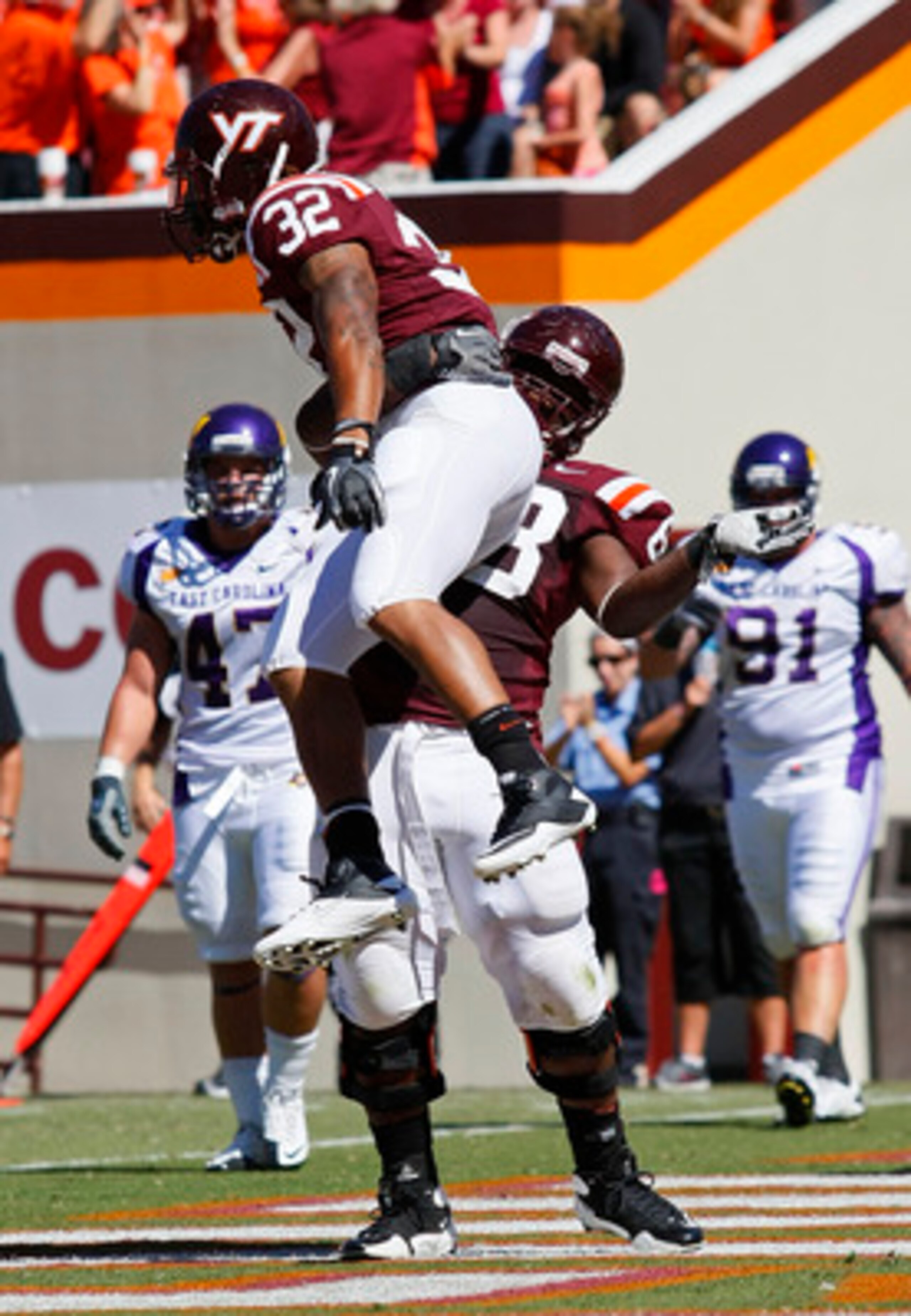 BLACKSBURG, VA - SEPTEMBER 18: Running back Darren Evans #32 and guard Jaymes Brooks #68 of the Virginia Tech Hokies celebrate a touchdown against the East Carolina Pirates at Lane Stadium on September 18, 2010 in Blacksburg, Virginia.  (Photo by Geoff Bu