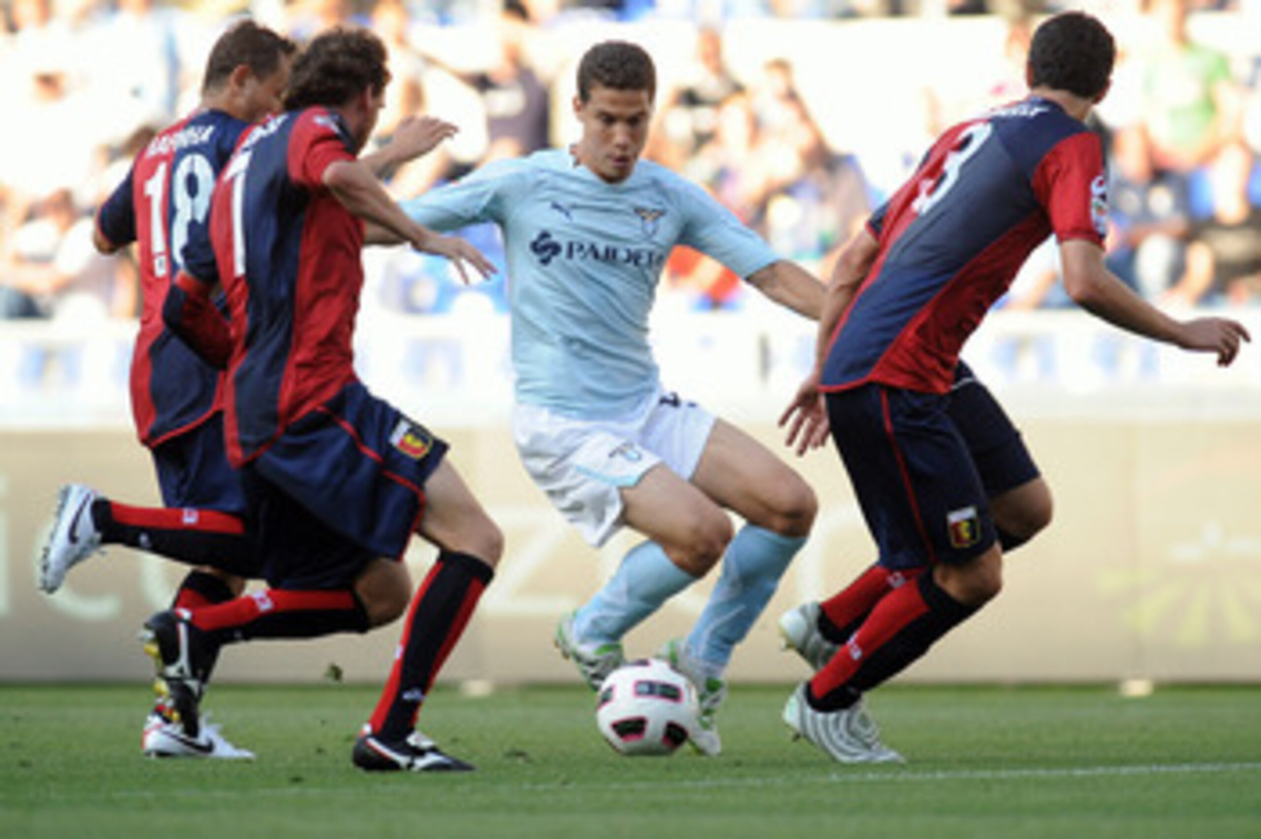 ROME, ITALY - MAY 14: Anderson Hernanes of SS Lazio in action against Rafinha Ferreira (L), Marco Rossi (C) and Dario Dainelli (R) of Genoa CFC during the Serie A match between SS Lazio and Genoa CFC at Stadio Olimpico on May 14, 2011 in Rome, Italy. (P ROME, ITALY - MAY 14: Anderson Hernanes of SS Lazio in action against Rafinha Ferreira (L), Marco Rossi (C) and Dario Dainelli (R) of Genoa CFC during the Serie A match between SS Lazio and Genoa CFC at Stadio Olimpico on May 14, 2011 in Rome, Italy. (P