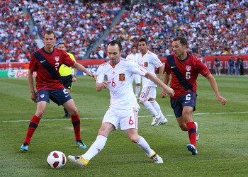FOXBORO, MA - JUNE 4:  Andres Iniesta #6 of Spain keeps the ball from Jonathan Spector #2 of the United States and Steve Cherundolo #6 of the United States at Gillette Stadium on June 4, 2011 in Foxboro, Massachusetts. Spain beat the United States 4-0. (P