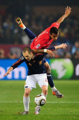 PRETORIA, SOUTH AFRICA - JUNE 25: Arturo Vidal of Chile challenges Andres Iniesta of Spain during the 2010 FIFA World Cup South Africa Group H match between Chile and Spain at Loftus Versfeld Stadium on June 25, 2010 in Tshwane/Pretoria, South Africa.  (P