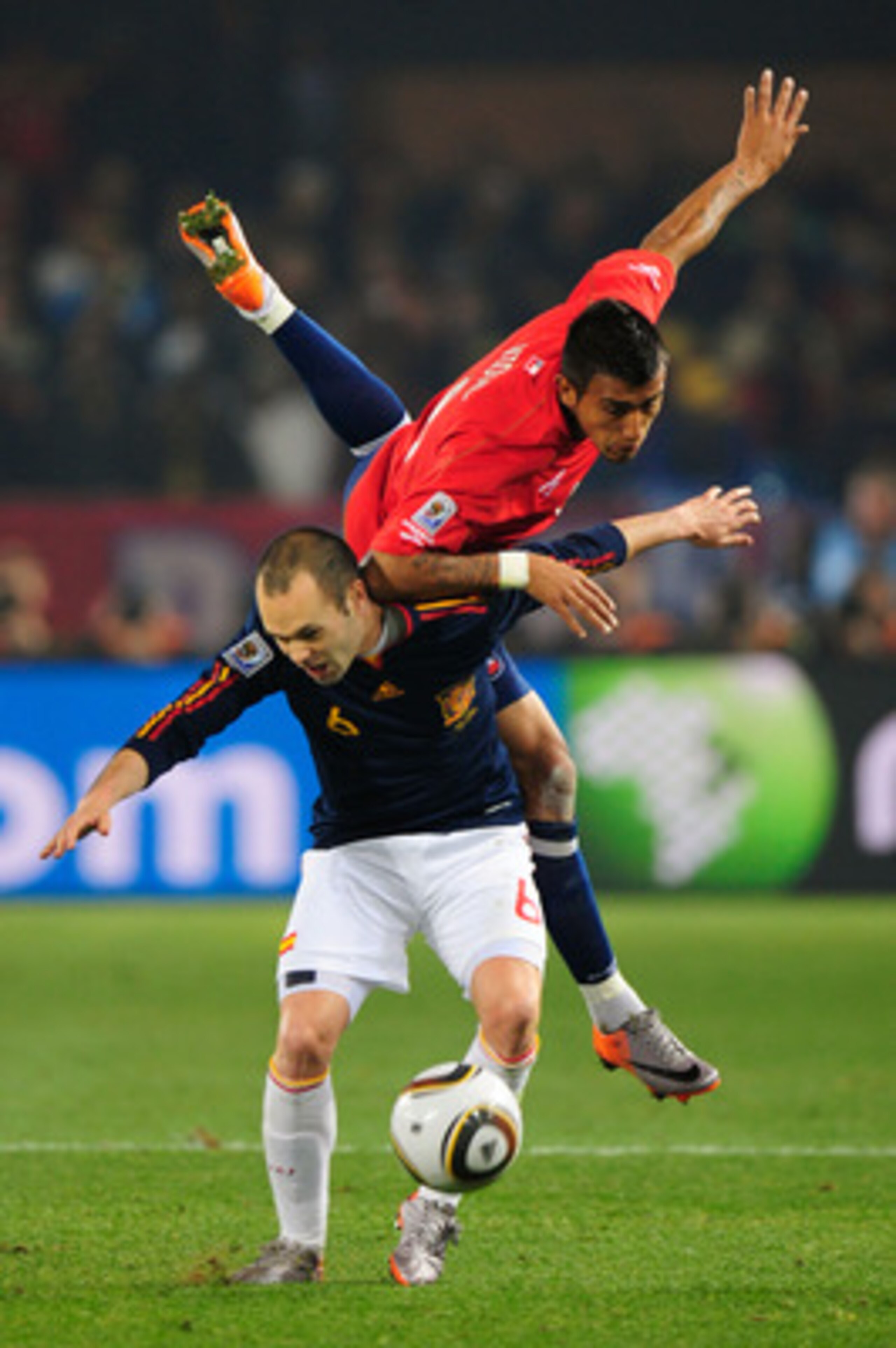 PRETORIA, SOUTH AFRICA - JUNE 25: Arturo Vidal of Chile challenges Andres Iniesta of Spain during the 2010 FIFA World Cup South Africa Group H match between Chile and Spain at Loftus Versfeld Stadium on June 25, 2010 in Tshwane/Pretoria, South Africa. (P PRETORIA, SOUTH AFRICA - JUNE 25: Arturo Vidal of Chile challenges Andres Iniesta of Spain during the 2010 FIFA World Cup South Africa Group H match between Chile and Spain at Loftus Versfeld Stadium on June 25, 2010 in Tshwane/Pretoria, South Africa. (P