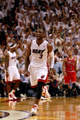 MIAMI, FL - MAY 24:  Dwyane Wade #3 of the Miami Heat celebrates as Derrick Rose #1 of the Chicago Bulls looks on dejected in Game Four of the Eastern Conference Finals during the 2011 NBA Playoffs on May 24, 2011 at American Airlines Arena in Miami, Flor