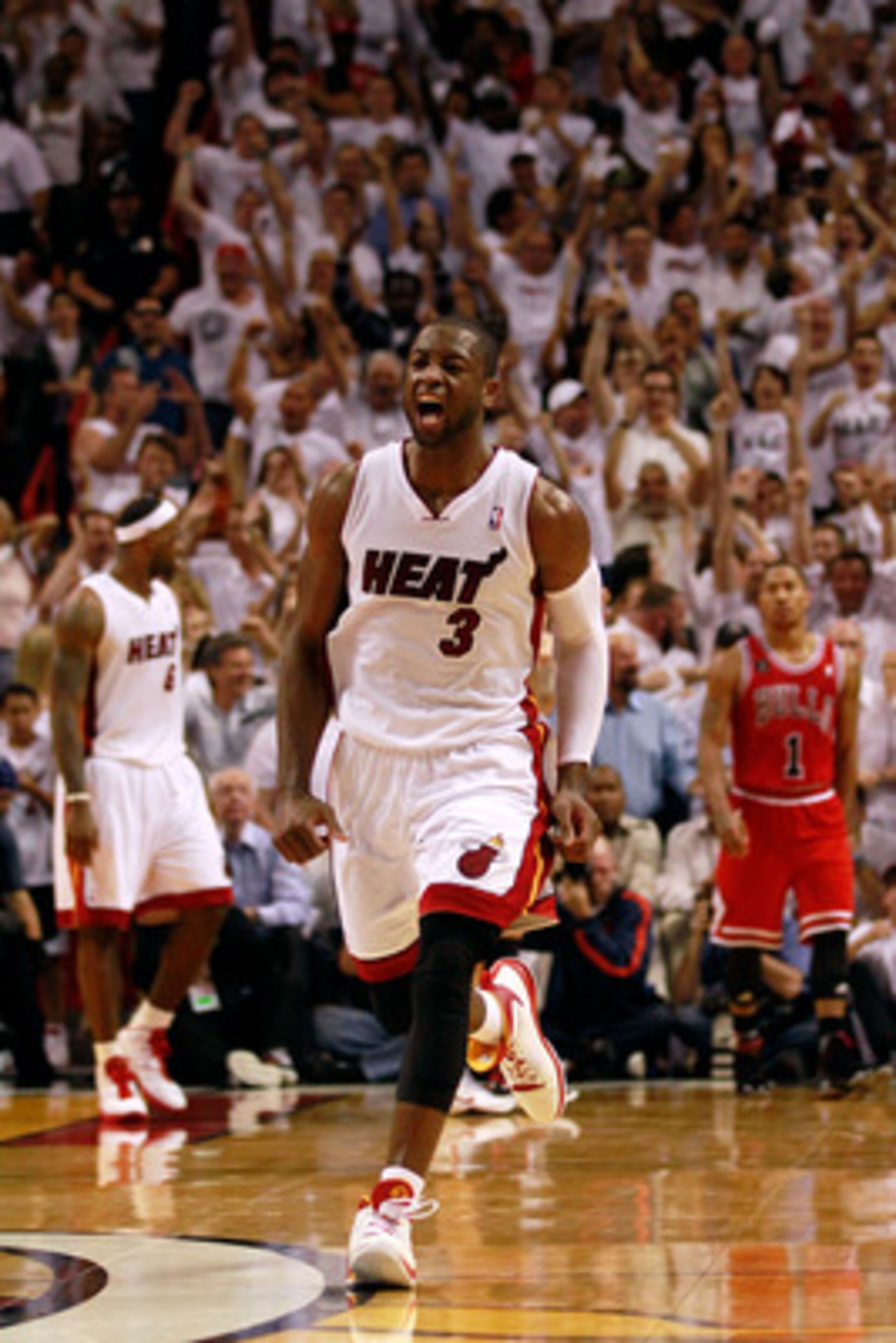 MIAMI, FL - MAY 24:  Dwyane Wade #3 of the Miami Heat celebrates as Derrick Rose #1 of the Chicago Bulls looks on dejected in Game Four of the Eastern Conference Finals during the 2011 NBA Playoffs on May 24, 2011 at American Airlines Arena in Miami, Flor