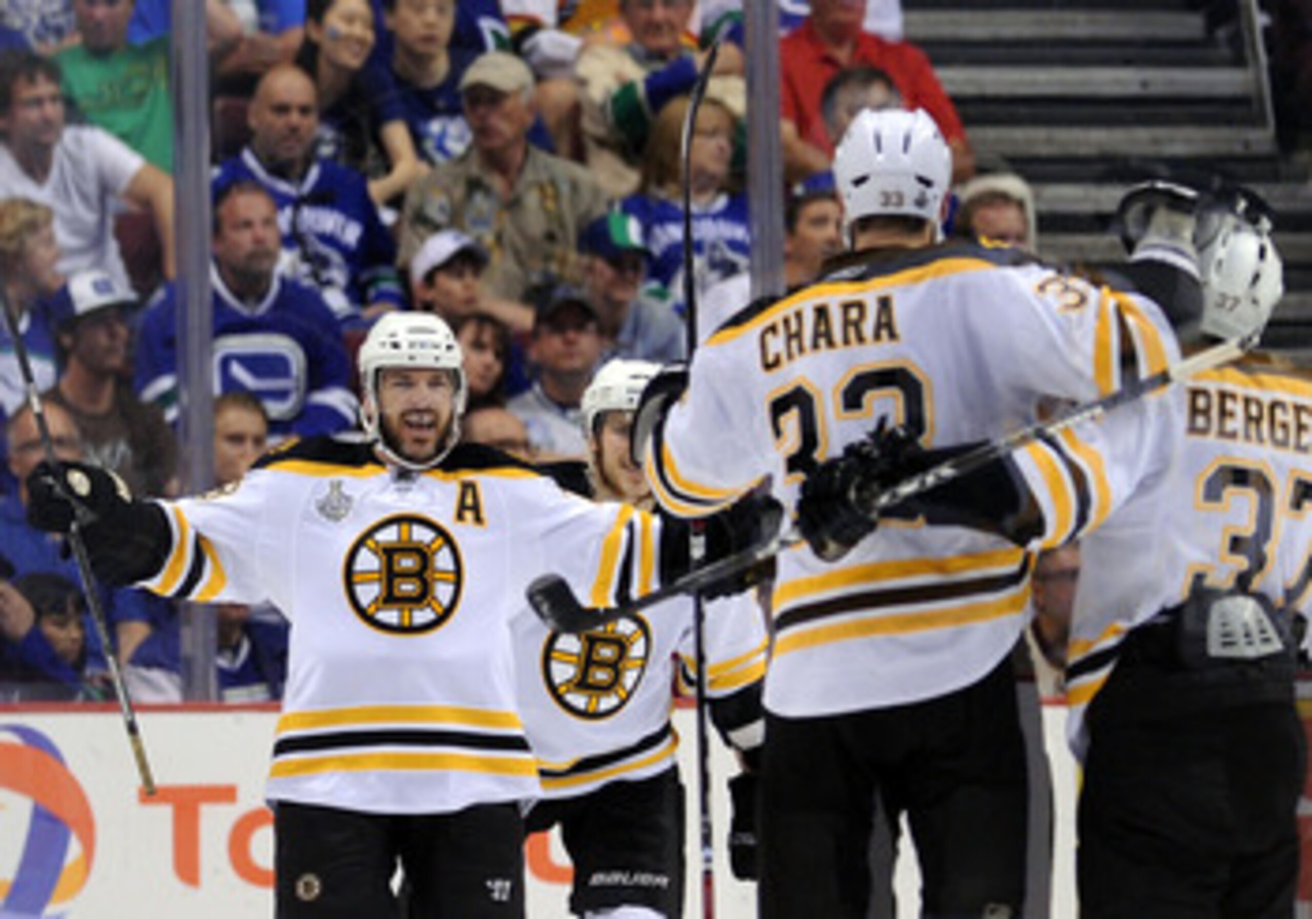 VANCOUVER, BC - JUNE 04:  Mark Recchi #28 of the Boston Bruins celebrates with his teammates Zdeno Chara #33 and Patrice Bergeron #37 after scoring a goal in the second period against Roberto Luongo #1 of the Vancouver Canucks during Game Two of the 2011 