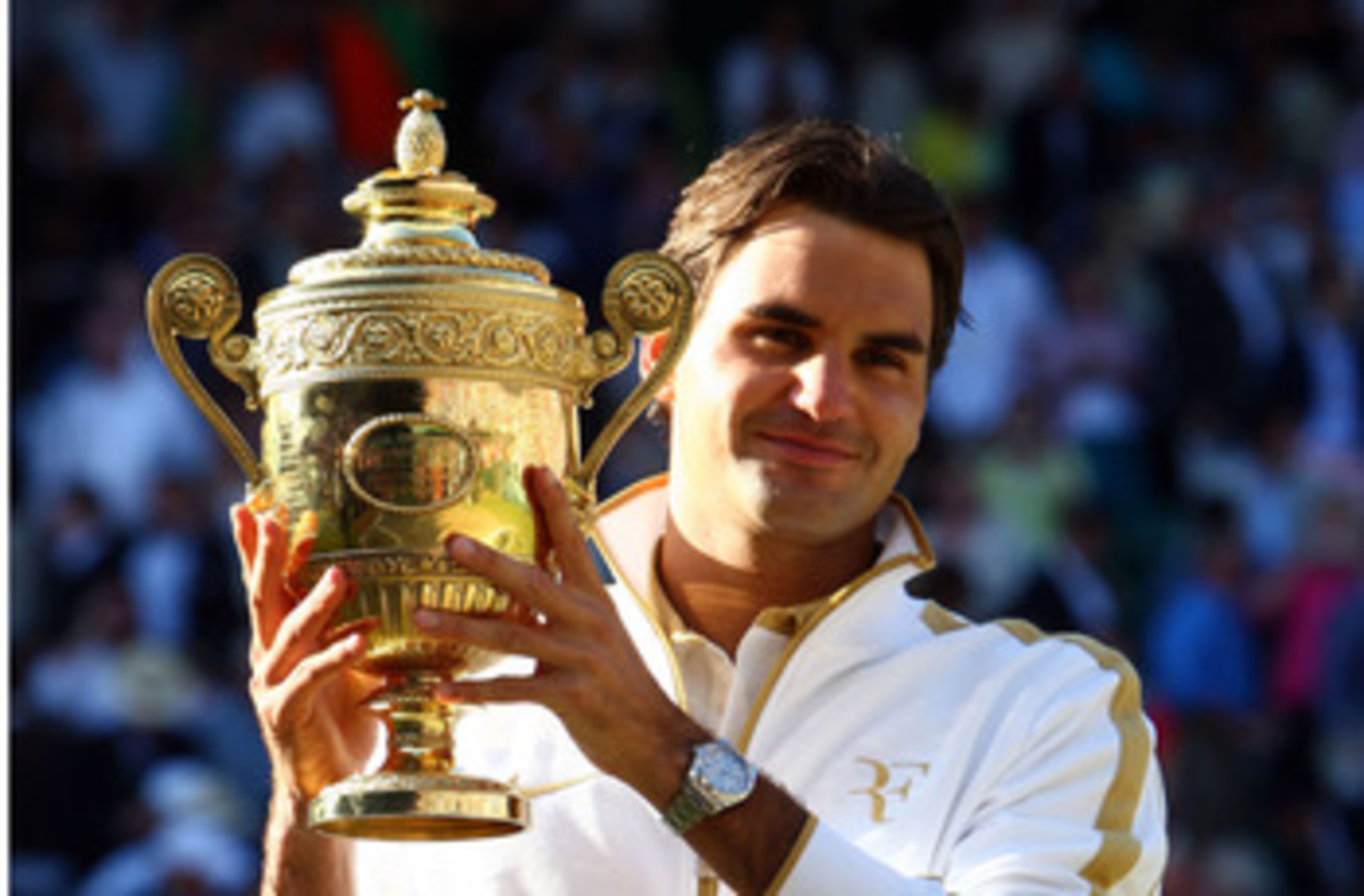 WIMBLEDON, ENGLAND - JULY 05:  Roger Federer of Switzerland celebrates victory with the trophy after the men's singles final match against Andy Roddick of USA on Day Thirteen of the Wimbledon Lawn Tennis Championships at the All England Lawn Tennis and Cr