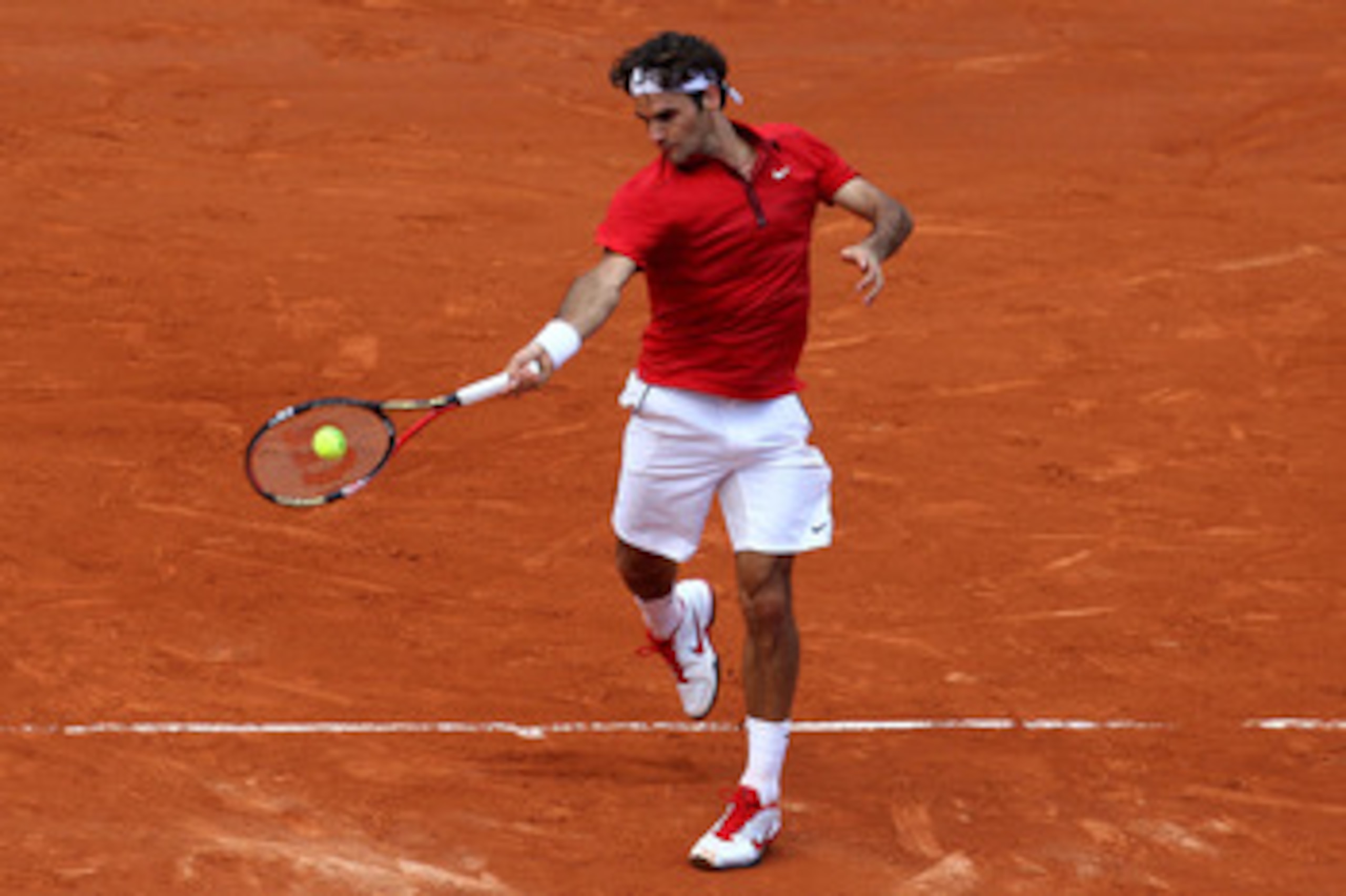 PARIS, FRANCE - JUNE 05: Roger Federer of Switzerland hits a forehand during the men's singles final match between Rafael Nadal of Spain and Roger Federer of Switzerland on day fifteen of the French Open at Roland Garros on June 5, 2011 in Paris, France. PARIS, FRANCE - JUNE 05: Roger Federer of Switzerland hits a forehand during the men's singles final match between Rafael Nadal of Spain and Roger Federer of Switzerland on day fifteen of the French Open at Roland Garros on June 5, 2011 in Paris, France.