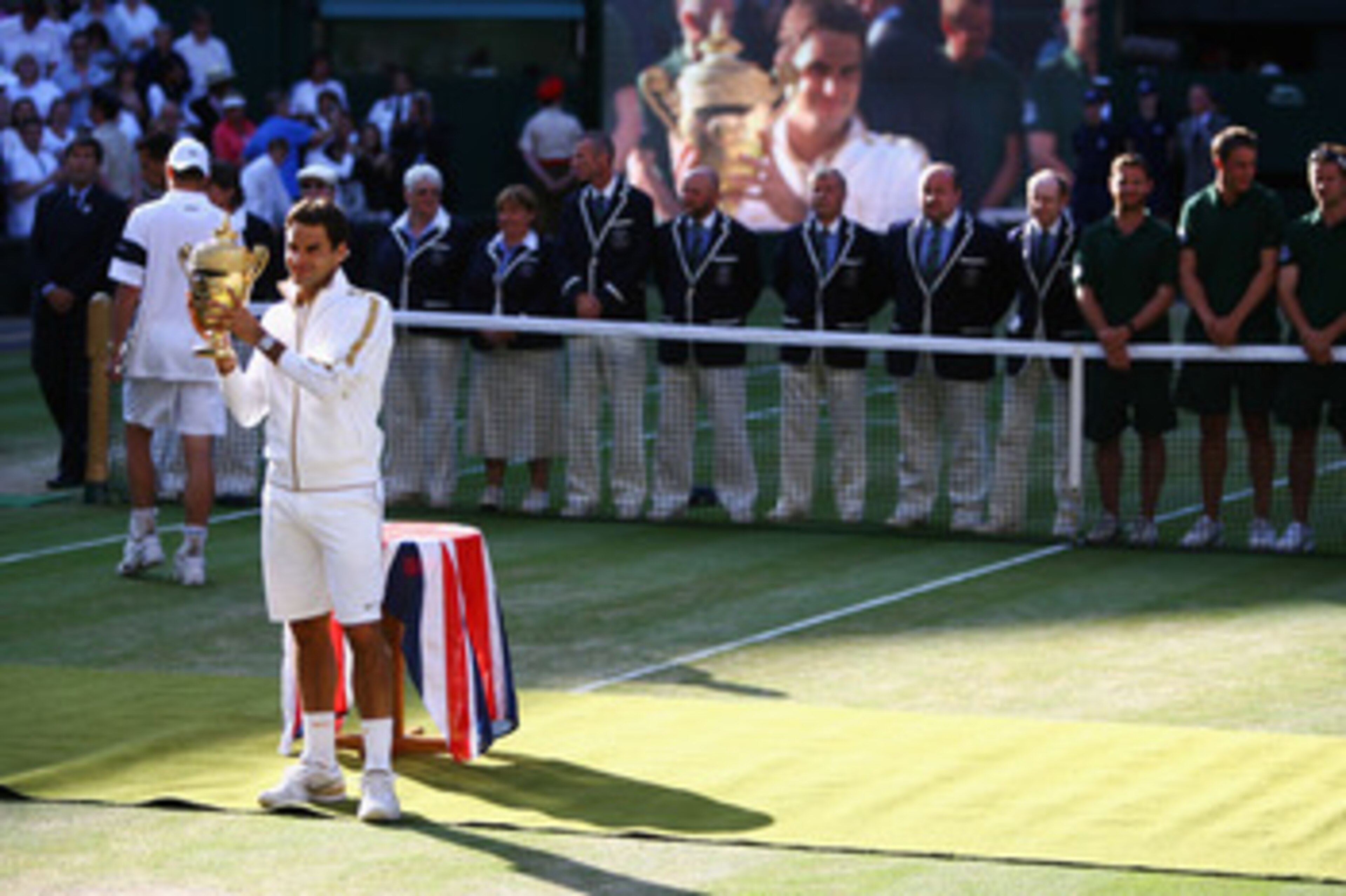 WIMBLEDON, ENGLAND - JULY 05:  Roger Federer of Switzerland poses with the trophy after the men's singles final match against Andy Roddick of USA on Day Thirteen of the Wimbledon Lawn Tennis Championships at the All England Lawn Tennis and Croquet Club on