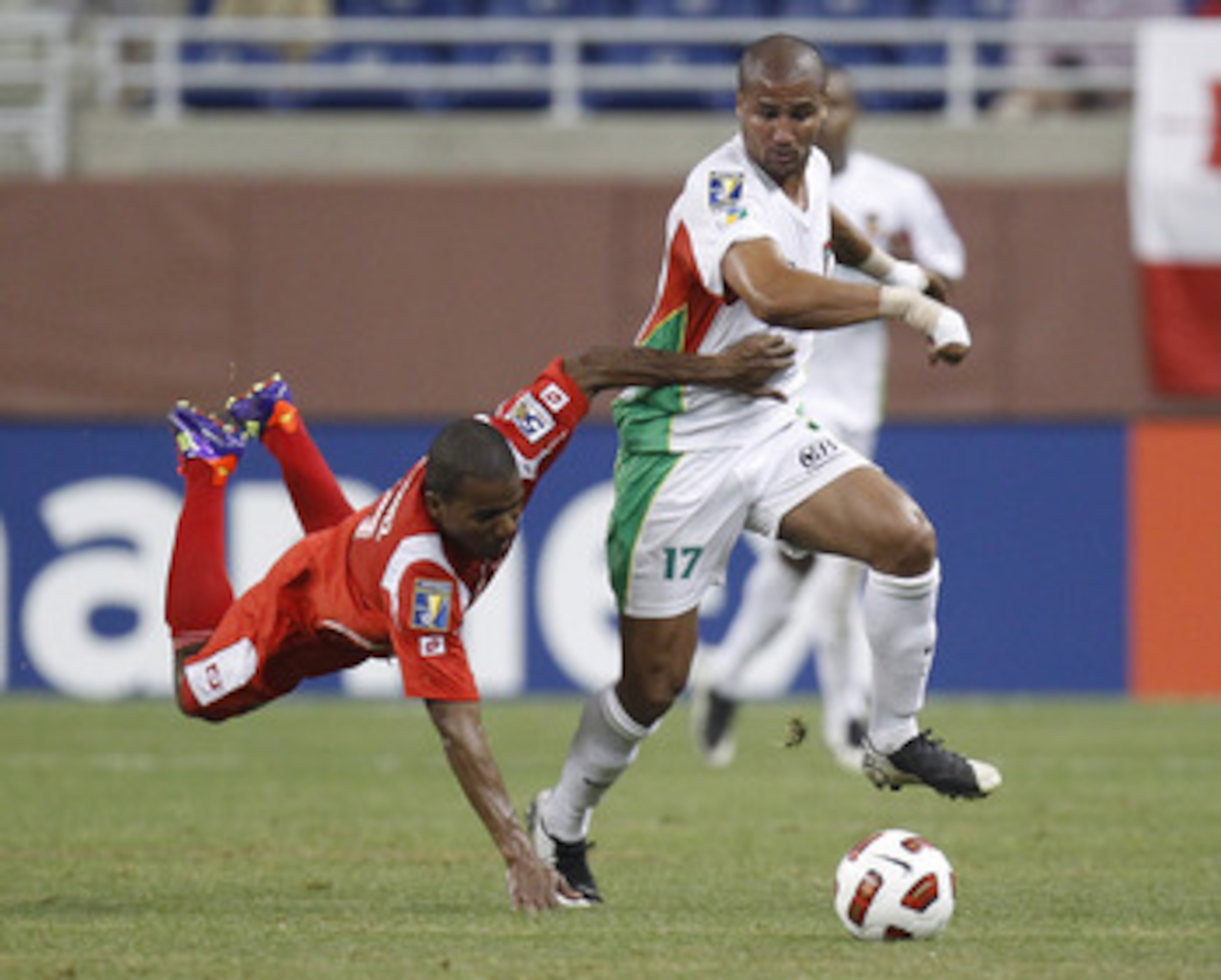DETROIT, MI - JUNE 7: Cedric Collet #17 of Guadeloupe drives past the diving Luis Henriquez #17 of Panama during the 2011 Gold Cup  at Ford Field on June 7, 2011 in Detroit, Michigan. Panama won the game 3-2. (Photo by Gregory Shamus/Getty Images)