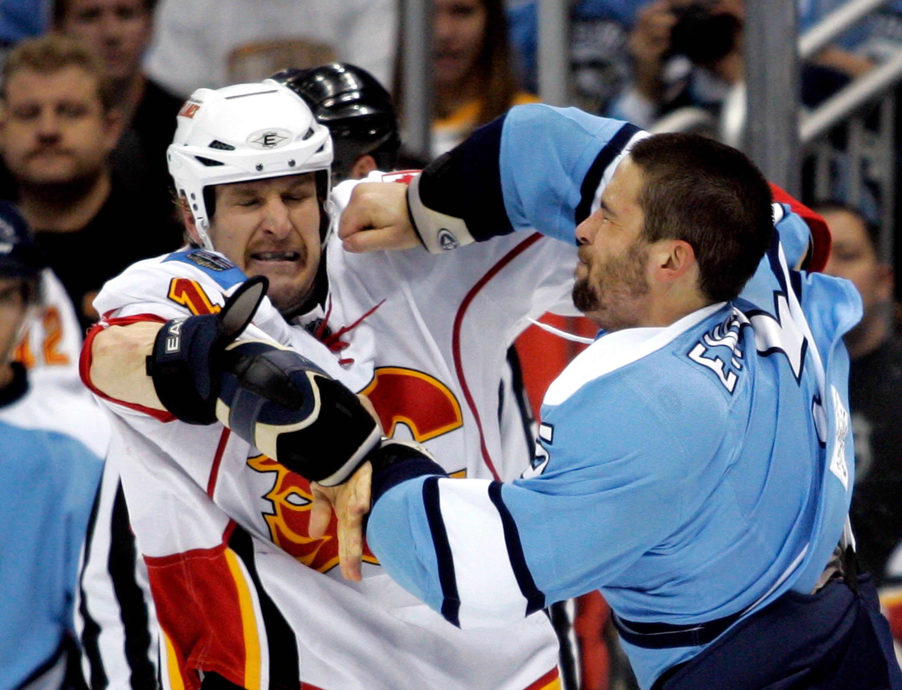 PITTSBURGH - NOVEMBER 27:  Tim Jackman #15 of the Calgary Flames and Deryk Engelland #5 of the Pittsburgh Penguins mix it up at Consol Energy Center on November 27, 2010 in Pittsburgh, Pennsylvania.  (Photo by Justin K. Aller/Getty Images)