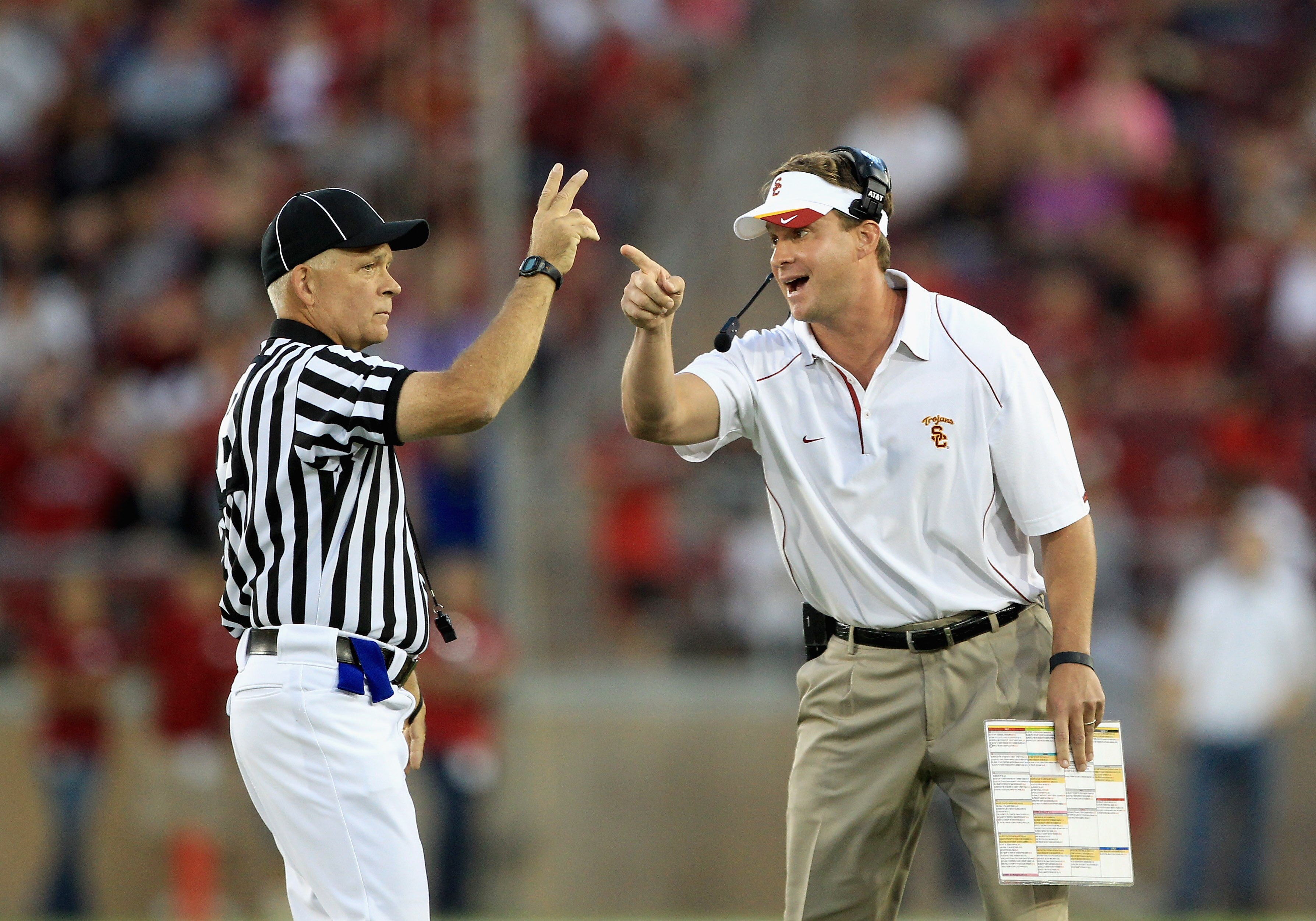 PALO ALTO, CA - OCTOBER 09:  USC Trojans head coach Lane Kiffin speaks with side judge Mike Weseloh during their loss to the Stanford Cardinal at Stanford Stadium on October 9, 2010 in Palo Alto, California.  (Photo by Ezra Shaw/Getty Images)