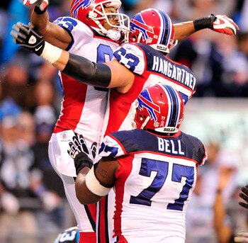 CHARLOTTE, NC - OCTOBER 25:  Lee Evans #83, Geoff Hangartner #63 and Demetrius Bell #77 of the Buffalo Bills celebrate Evans' touchdown against the Carolina Panthers at Bank of America Stadium on October 25, 2009 in Charlotte, North Carolina. Buffalo won 