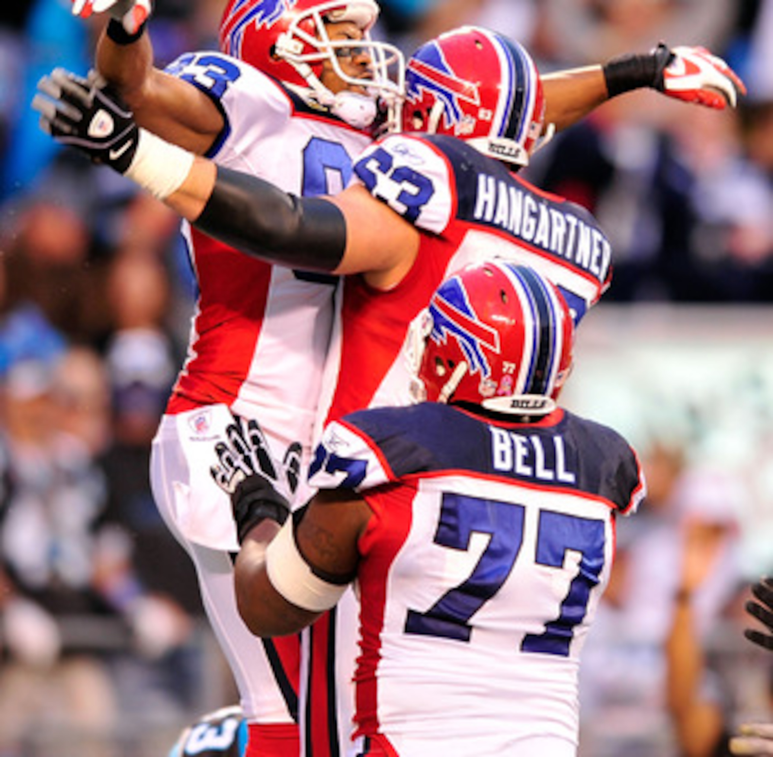 CHARLOTTE, NC - OCTOBER 25:  Lee Evans #83, Geoff Hangartner #63 and Demetrius Bell #77 of the Buffalo Bills celebrate Evans' touchdown against the Carolina Panthers at Bank of America Stadium on October 25, 2009 in Charlotte, North Carolina. Buffalo won 