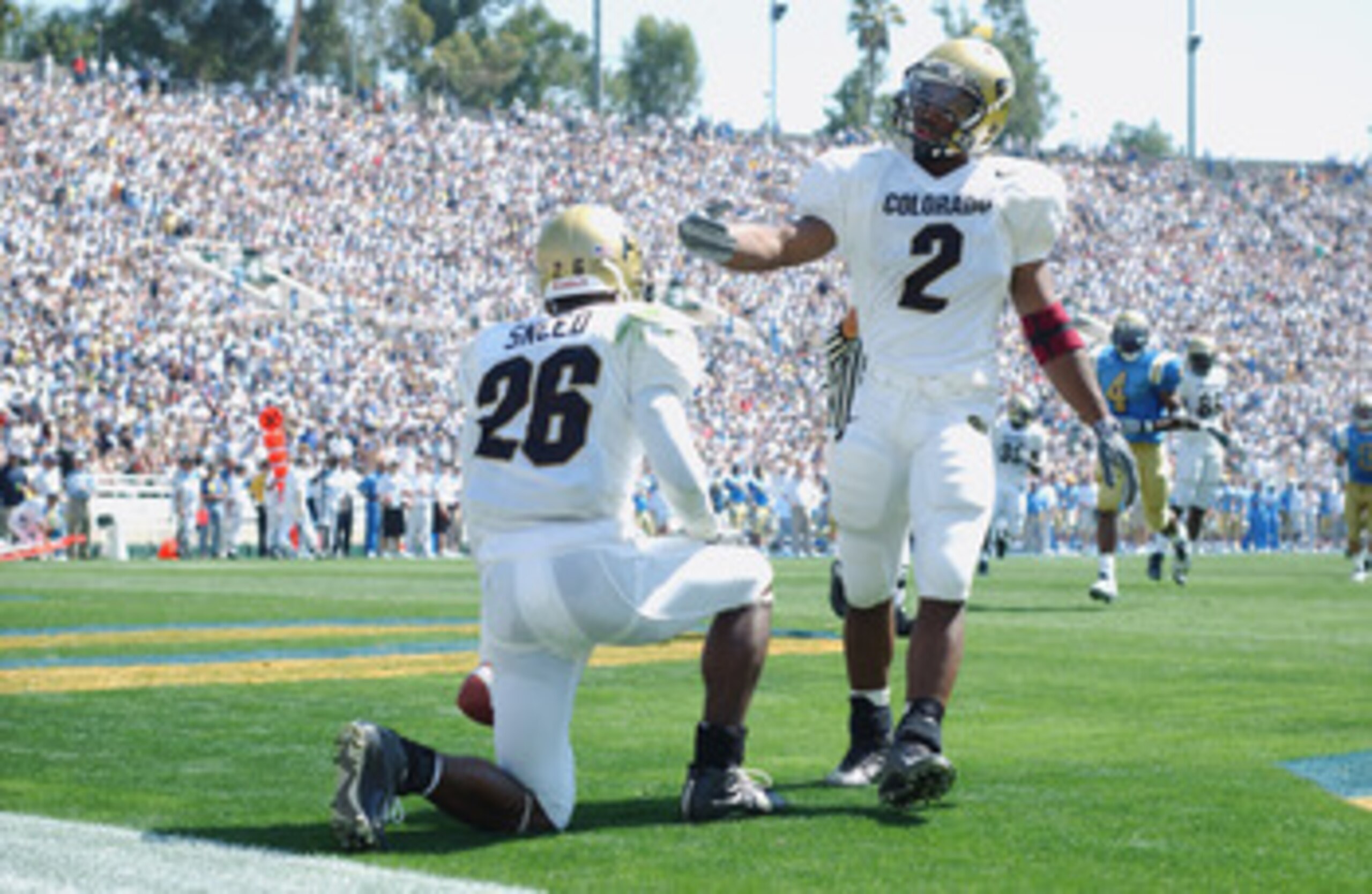 PASADENA, CA - SEPTEMBER 21:  Defensive back Roderick Sneed #26 of the Colorado Buffaloes takes the advice of running back Brian Calhoun #2 and takes the touchback during the NCAA football game against the UCLA Bruins on September 21, 2002 at the Rose Bow