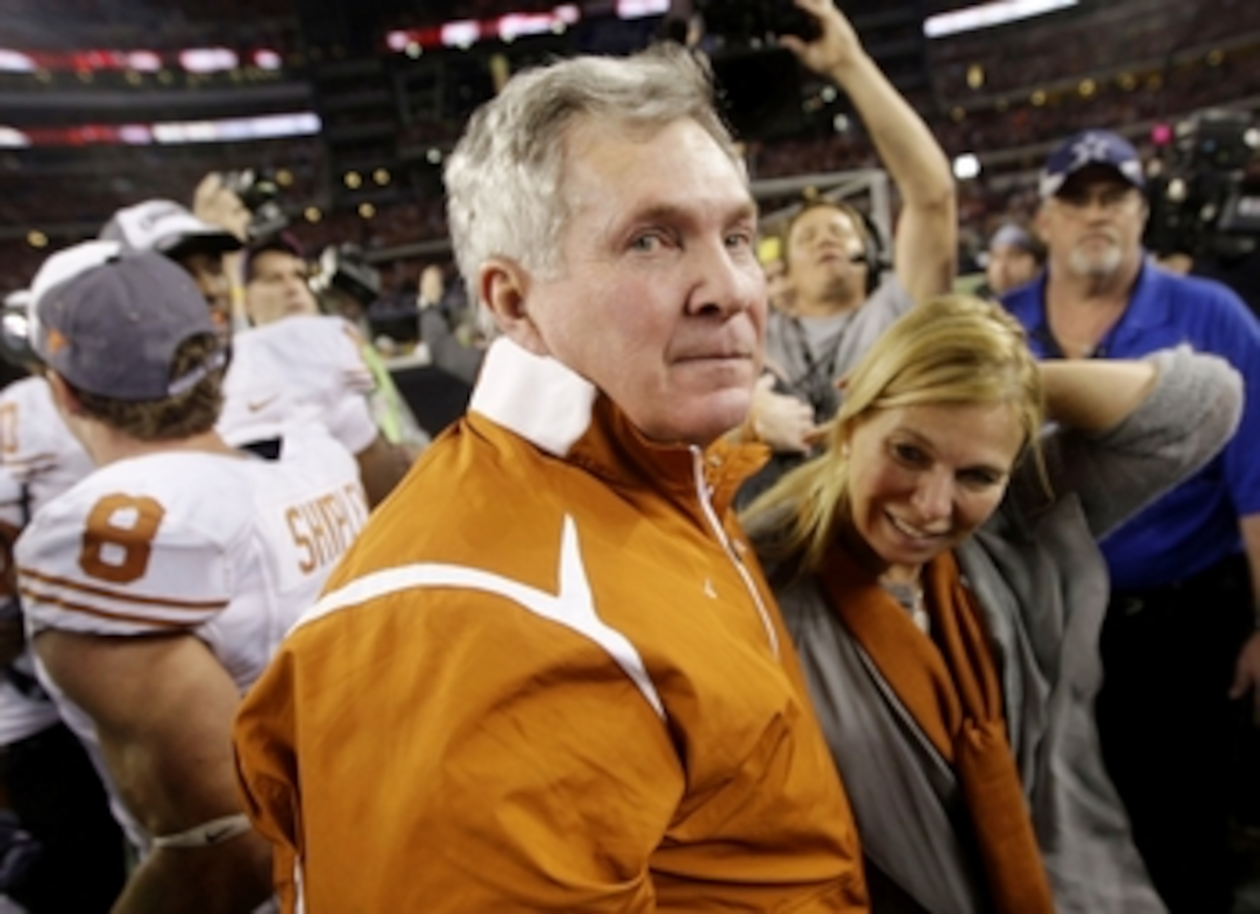 ARLINGTON, TX - DECEMBER 5: Head coach Mack Brown of the Texas Longhorns celebrates with his wife after his team won the game 10-6 over the Nebraska Cornhuskers at Cowboys Stadium on December 5, 2009 in Arlington, Texas. (Photo by Jamie Squire/Getty Image ARLINGTON, TX - DECEMBER 5: Head coach Mack Brown of the Texas Longhorns celebrates with his wife after his team won the game 10-6 over the Nebraska Cornhuskers at Cowboys Stadium on December 5, 2009 in Arlington, Texas. (Photo by Jamie Squire/Getty Image