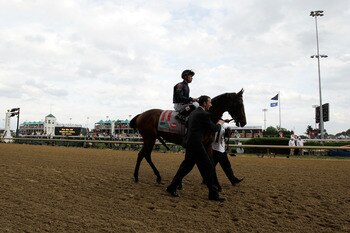 LOUISVILLE, KY - MAY 07:  Jockey Garrett Gomez, riding Master of Hounds #11, is escourted onto the track for the running of the 137th Kentucky Derby at Churchill Downs on May 7, 2011 in Louisville, Kentucky.  (Photo by Rob Carr/Getty Images)
