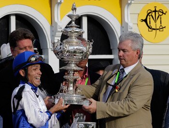 BALTIMORE, MD - MAY 21:  Jockey Jesus Castanon (L) and co-owner Mike Lauffer (R) hold the trophy in the winners circle after their horse Shackleford won the 136th running of the Preakness Stakes at Pimlico Race Course on May 21, 2011 in Baltimore, Marylan