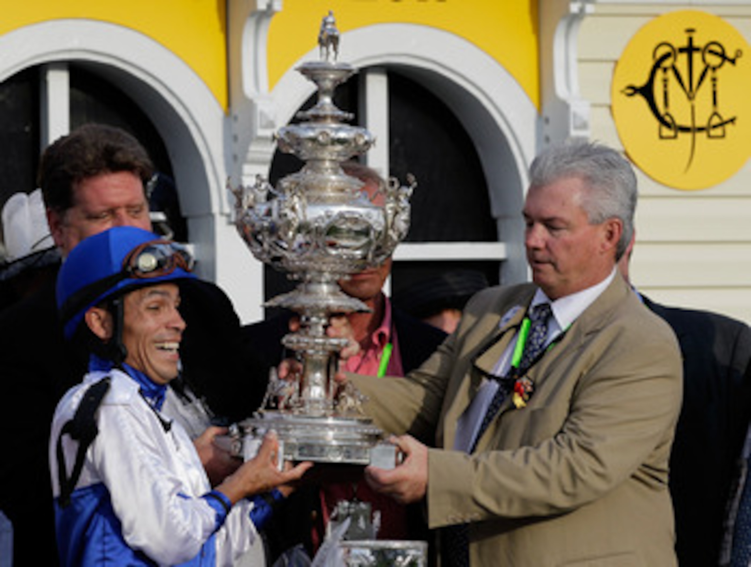 BALTIMORE, MD - MAY 21: Jockey Jesus Castanon (L) and co-owner Mike Lauffer (R) hold the trophy in the winners circle after their horse Shackleford won the 136th running of the Preakness Stakes at Pimlico Race Course on May 21, 2011 in Baltimore, Marylan BALTIMORE, MD - MAY 21: Jockey Jesus Castanon (L) and co-owner Mike Lauffer (R) hold the trophy in the winners circle after their horse Shackleford won the 136th running of the Preakness Stakes at Pimlico Race Course on May 21, 2011 in Baltimore, Marylan