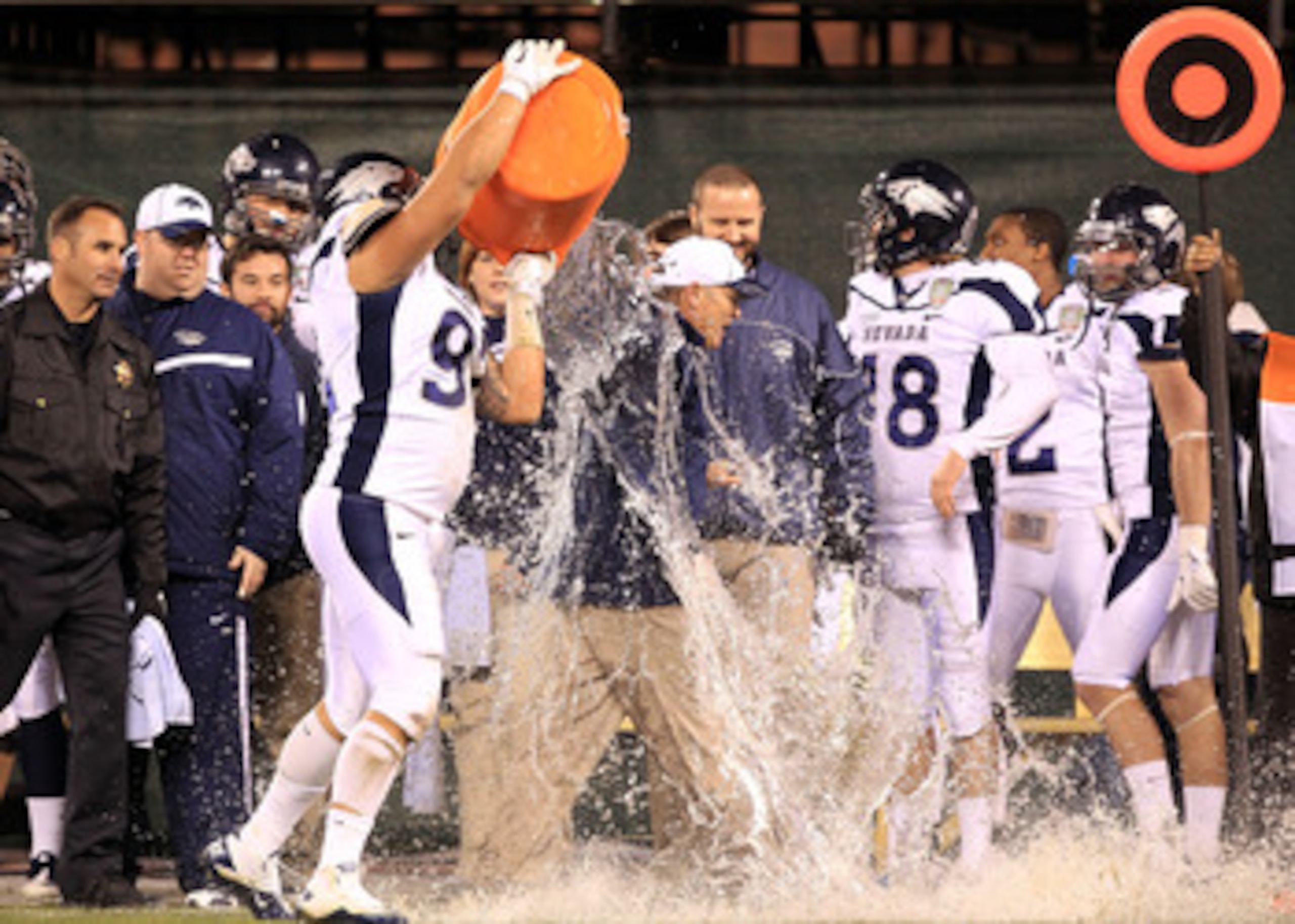 SAN FRANCISCO, CA - JANUARY 09:  Head coach Chris Ault of the Nevada Wolf Pack is covered in water by Mike Andrews #92  in the closing minute of their victory over Boston College in the Kraft Fight Hunger Bowl at AT&T Park on January 9, 2011 in San Franci