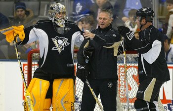 TORONTO - DECEMBER 1:  Marc-Andre Fleury #29 of the Pittsburgh Penguins and teammate Mark Recchi #8 listen to goaltending coach Gilles Meloche during an open practice before facing the Toronto Maple Leafs in their NHL game at the Air Canada Centre Decembe