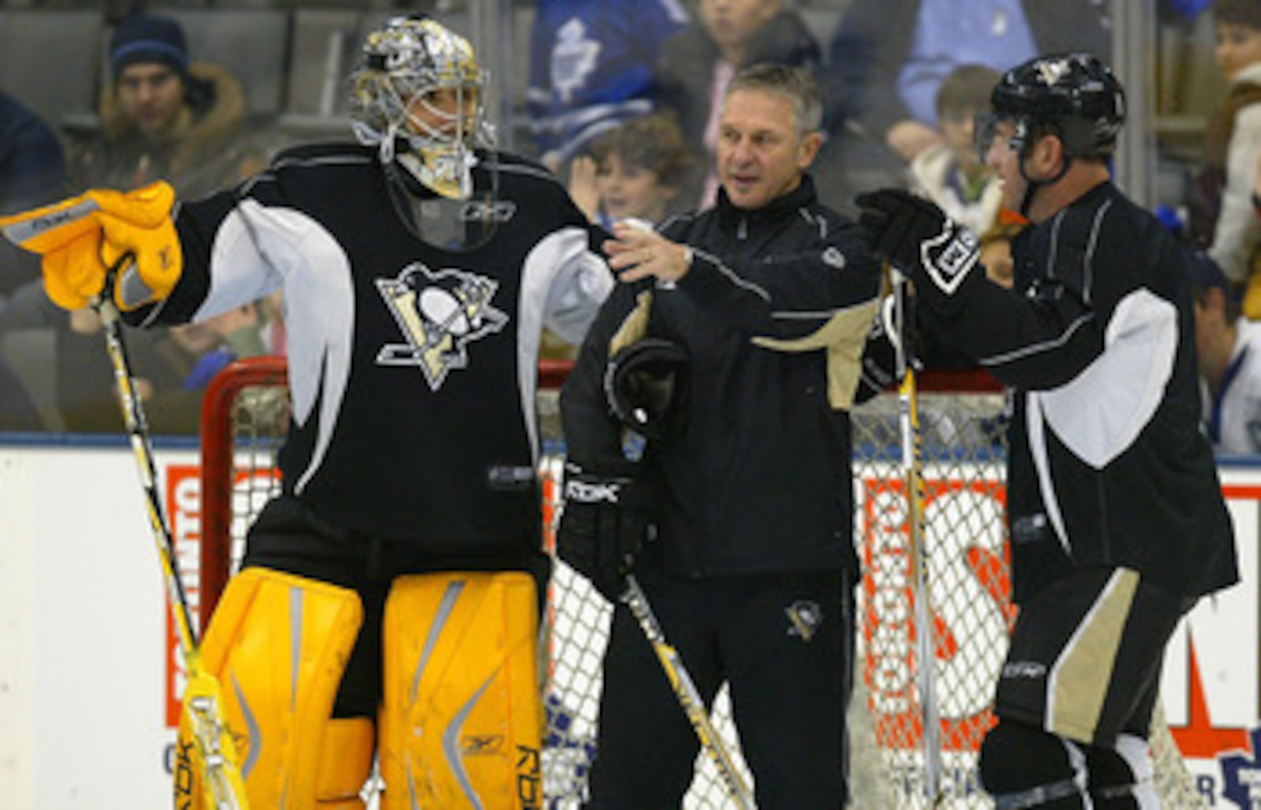 TORONTO - DECEMBER 1:  Marc-Andre Fleury #29 of the Pittsburgh Penguins and teammate Mark Recchi #8 listen to goaltending coach Gilles Meloche during an open practice before facing the Toronto Maple Leafs in their NHL game at the Air Canada Centre Decembe