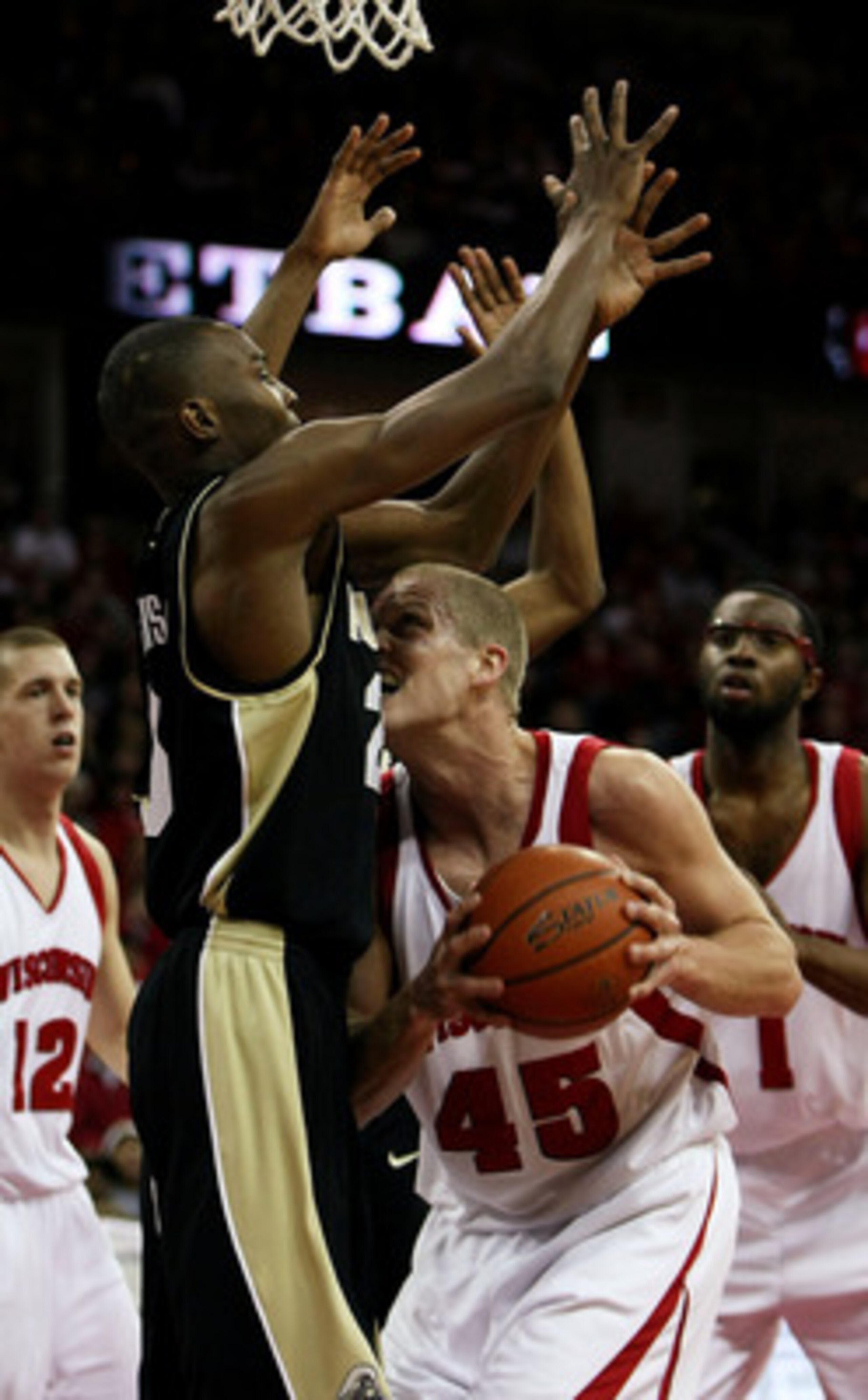 MADISON, WI - FEBRUARY 09: Joe Krabbenhoft #45 of the Wisconsin Badgers runs into JaJuan Johnson #25 of the Purdue Boilermakers as he tries to shoot on February 9, 2008 at the Kohl Center in Madison, Wisconsin. (Photo by Jonathan Daniel/Getty Images)
