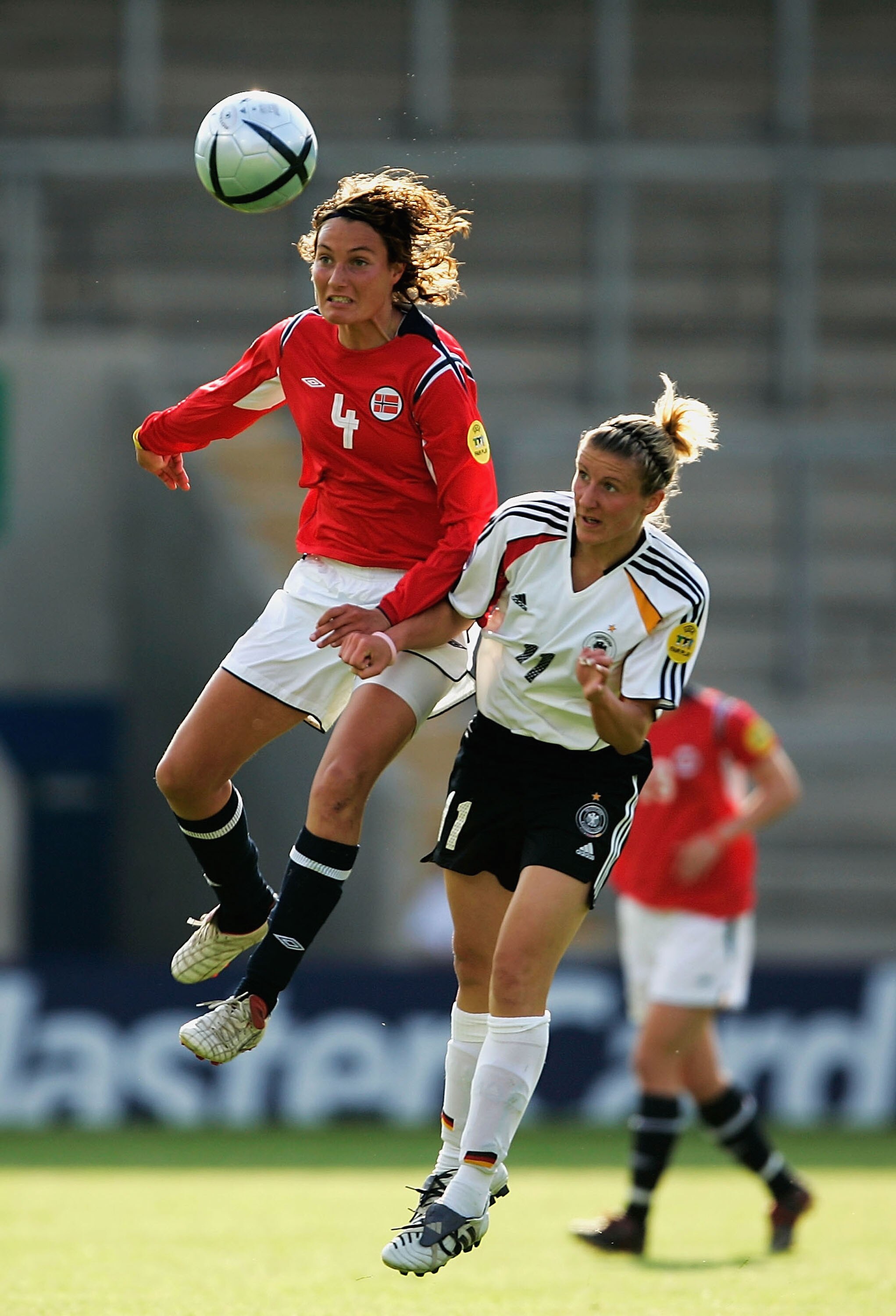 WARRINGTON, ENGLAND - JUNE 6:  Ingvild Stensland of Norway heads the ball away from Anja Mittag of Germany during the Women's UEFA European Championship 2005 Group B match between Germany and Norway at the Halliwell Jones Stadium on June 6, 2005 in Warrin