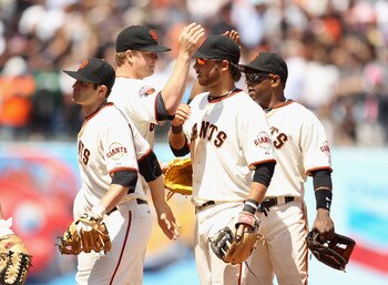 SAN FRANCISCO, CA - JUNE 08:  Matt Cain #18 of the San Francisco Giants is congratulated by Brandon Crawford #35, Freddy Sanchez #21 and Miguel Tejada #10 after they beat the Washington Nationals at AT&T Park on June 8, 2011 in San Francisco, California.