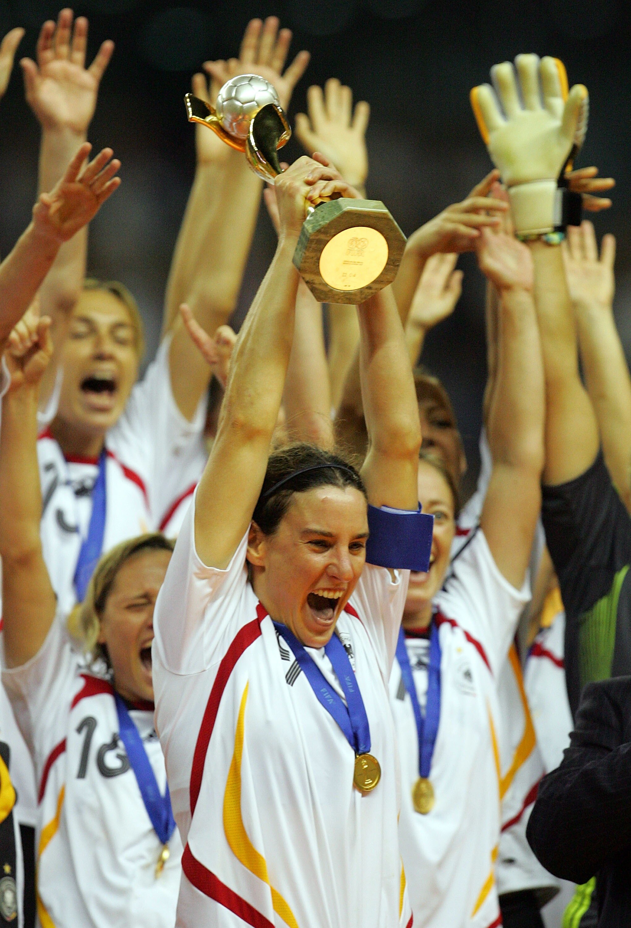 SHANGHAI, CHINA - SEPTEMBER 30:  Forward Birgit Prinz #9 of Germany raises the FIFA Women's World Cup 2007 trophy after defeating Brazil 2-0 at Shanghai Hongkou Football Stadium on September 30, 2007 in Shanghai, China.  (Photo by Ronald Martinez/Getty Im