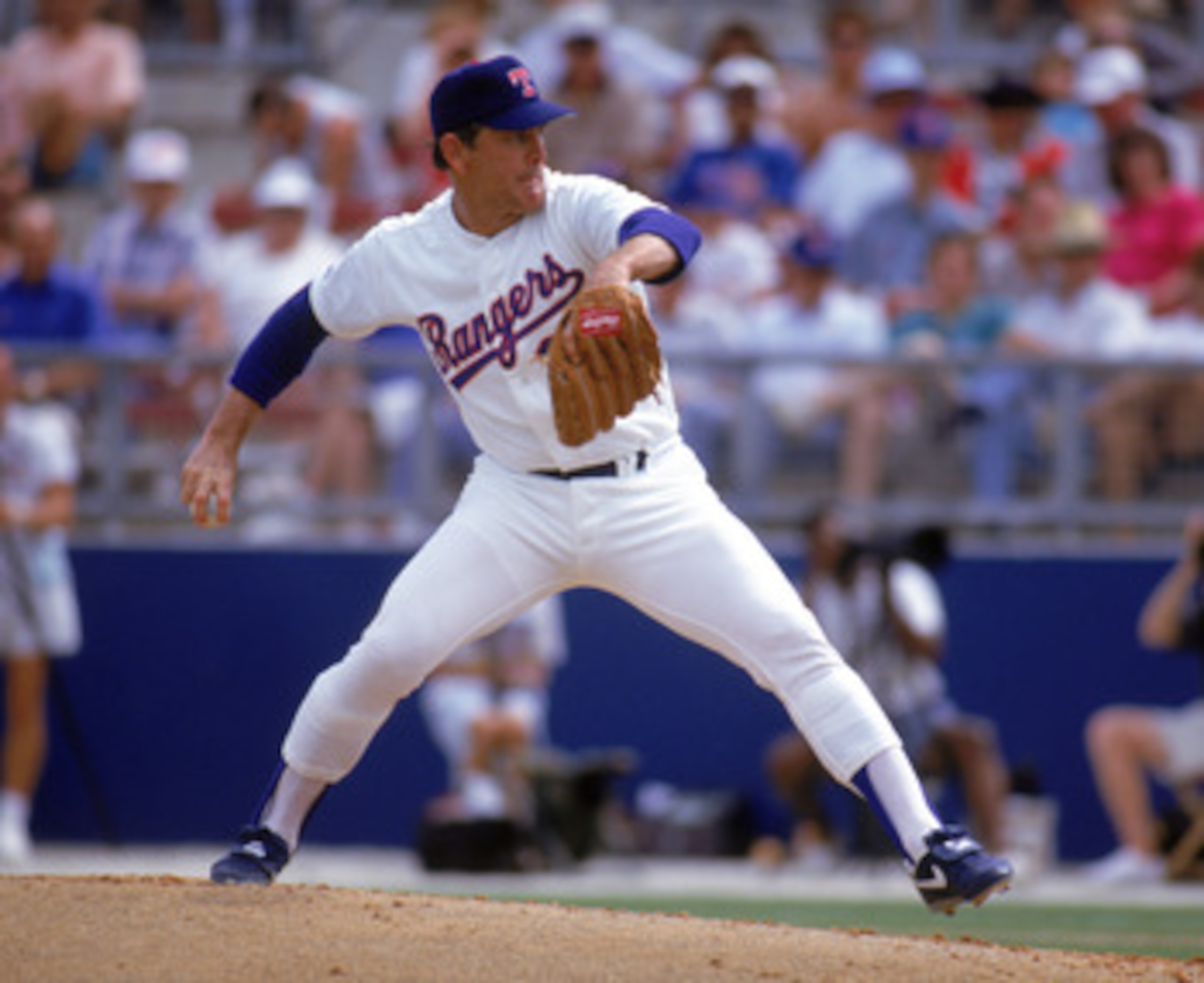 ARLINGTON, TX - 1990s:  Nolan Ryan #34 of the Texas Rangers pitches during a circa 1990s game at Arlington Stadium in Arlington, Texas. Ryan pitched for the Rangers from 1989-93.  (Photo by Jonathan Daniel/Getty Images)