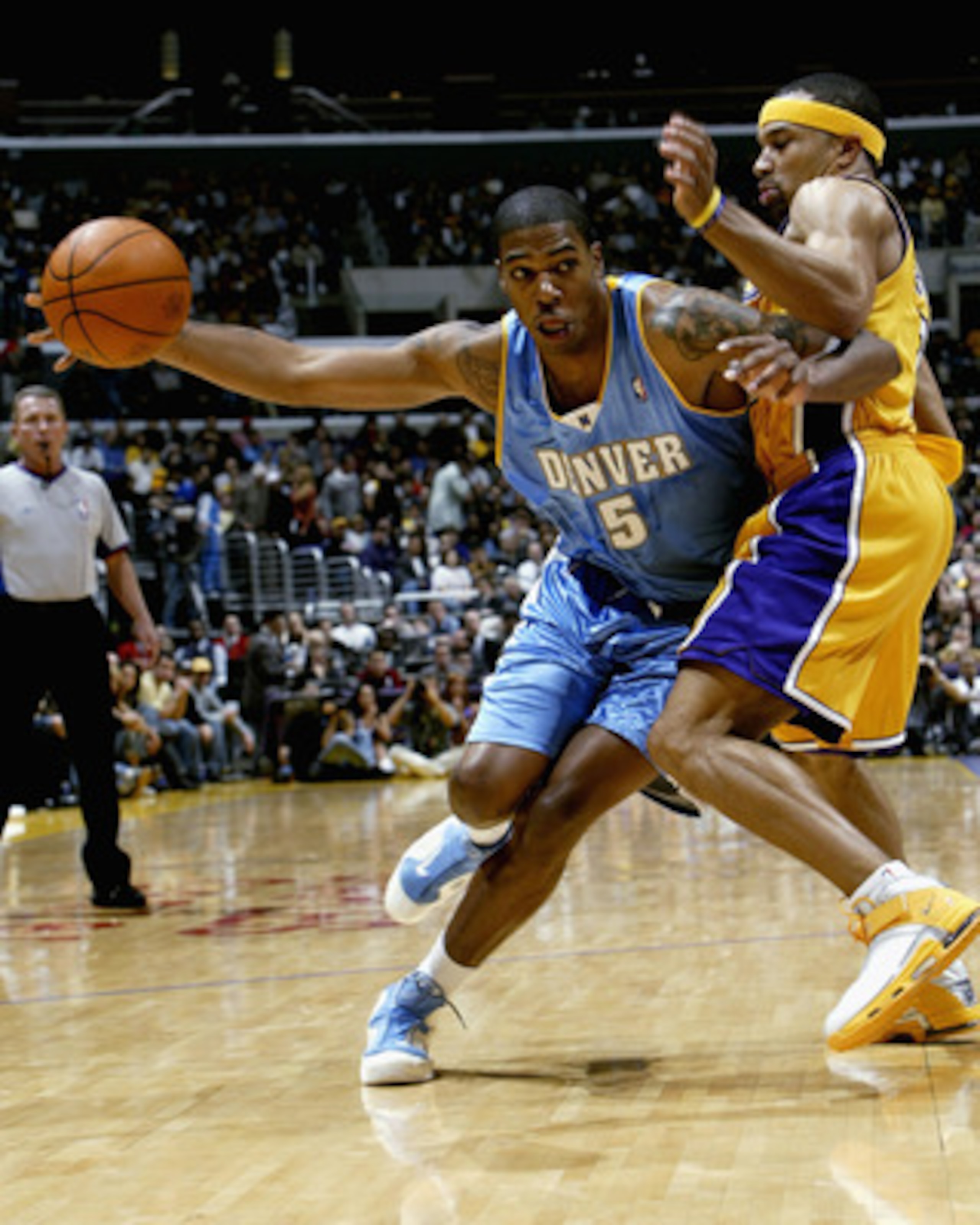LOS ANGELES - DECEMBER 19: Rodney White #5 of the Denver Nuggets drives around Derek Fisher #2 of the Los Angeles Lakers on December 19, 2003 at Staples Center in Los Angeles, California. The Lakers won 94-92. NOTE TO USER: User Expressly acknowledges and