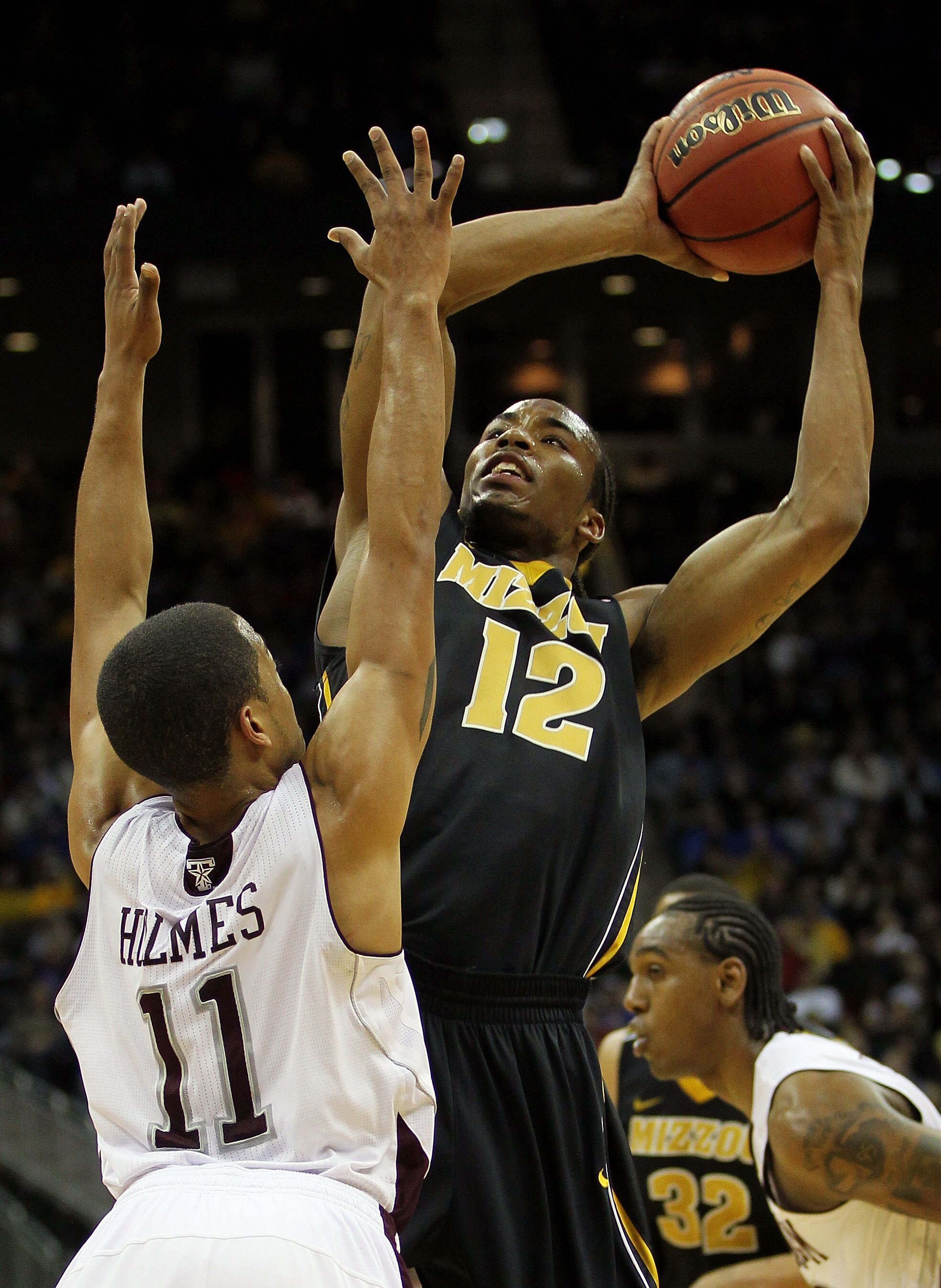 KANSAS CITY, MO - MARCH 10:  Marcus Denmon #12 of the Missouri Tigers goes up for a shot against B.J. Holmes #11 of the Texas A&M Aggies during their quarterfinal game in the 2011 Phillips 66 Big 12 Men's Basketball Tournament at Sprint Center on March 10